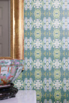 Luxury abstract floral wallpaper in rich dark green tones with layered organic movement, designed for modern traditional and collected interiors.