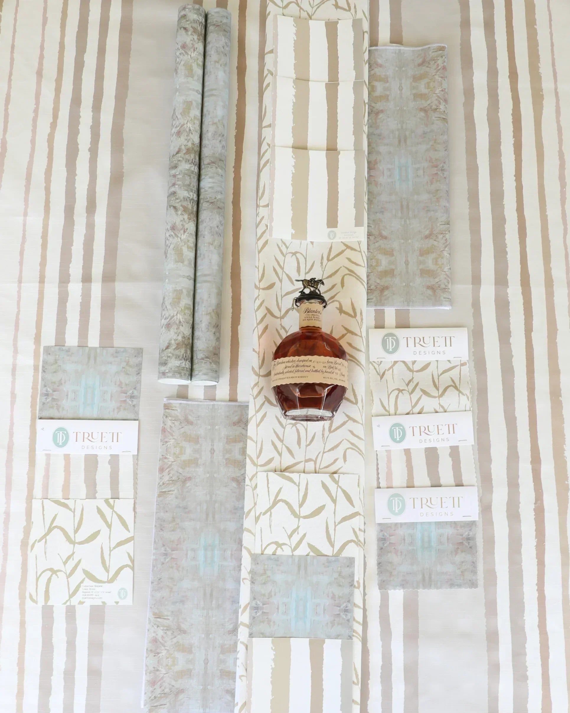 Luxury botanical fabric in warm brass tones with layered painterly organic design, ideal for upholstery, drapery, and sophisticated contemporary interiors.