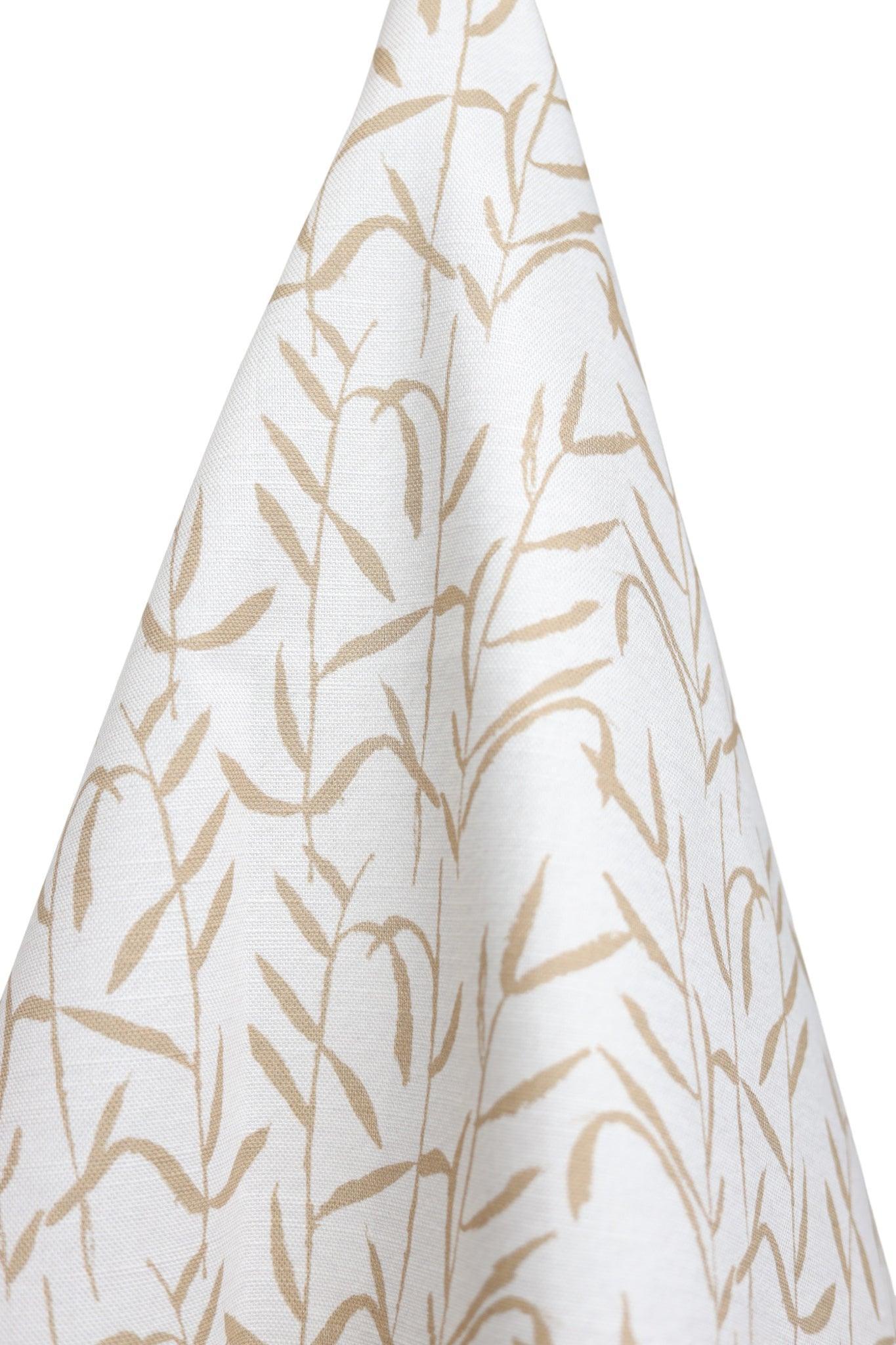 Luxury botanical fabric in warm brass tones with layered painterly organic design, ideal for upholstery, drapery, and sophisticated contemporary interiors.
