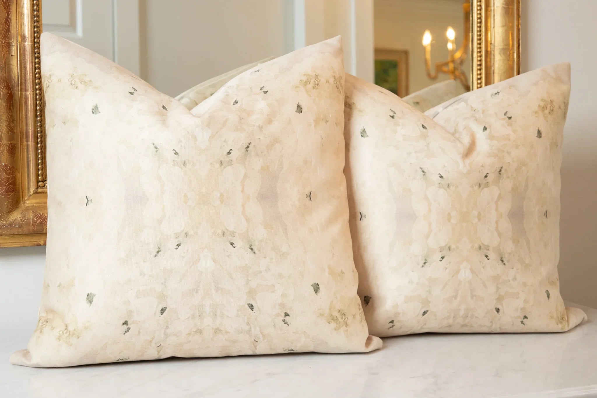 Centerpiece White Hydrangea luxury decorative pillow featuring a large-scale abstract floral pattern in layered white, cream, and deep olive green tones, handcrafted in England for luxury living rooms, designer-curated interiors, tailored upholstery, and thoughtfully layered homes.