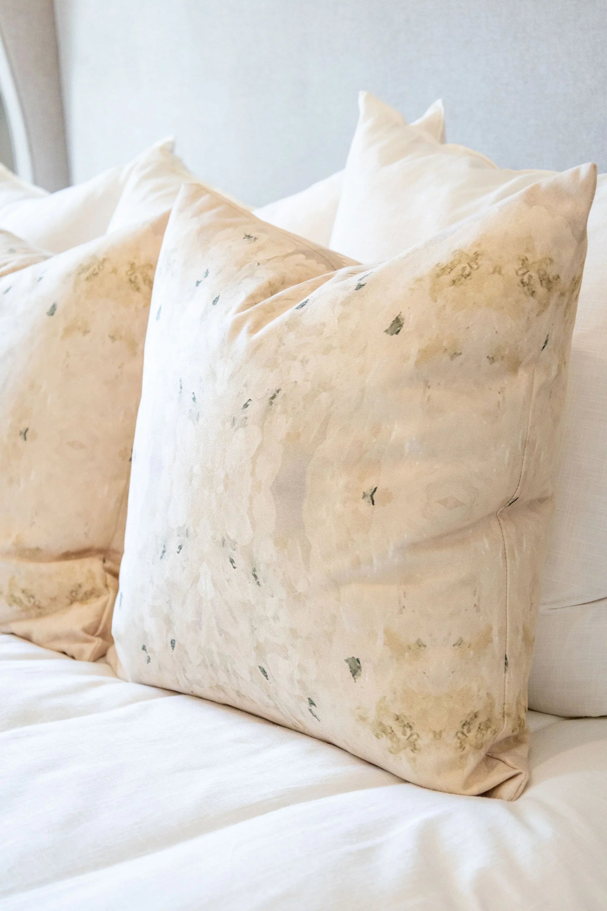 Centerpiece White Hydrangea luxury decorative pillow featuring a large-scale abstract floral pattern in layered white, cream, and deep olive green tones, handcrafted in England for luxury living rooms, designer-curated interiors, tailored upholstery, and thoughtfully layered homes.