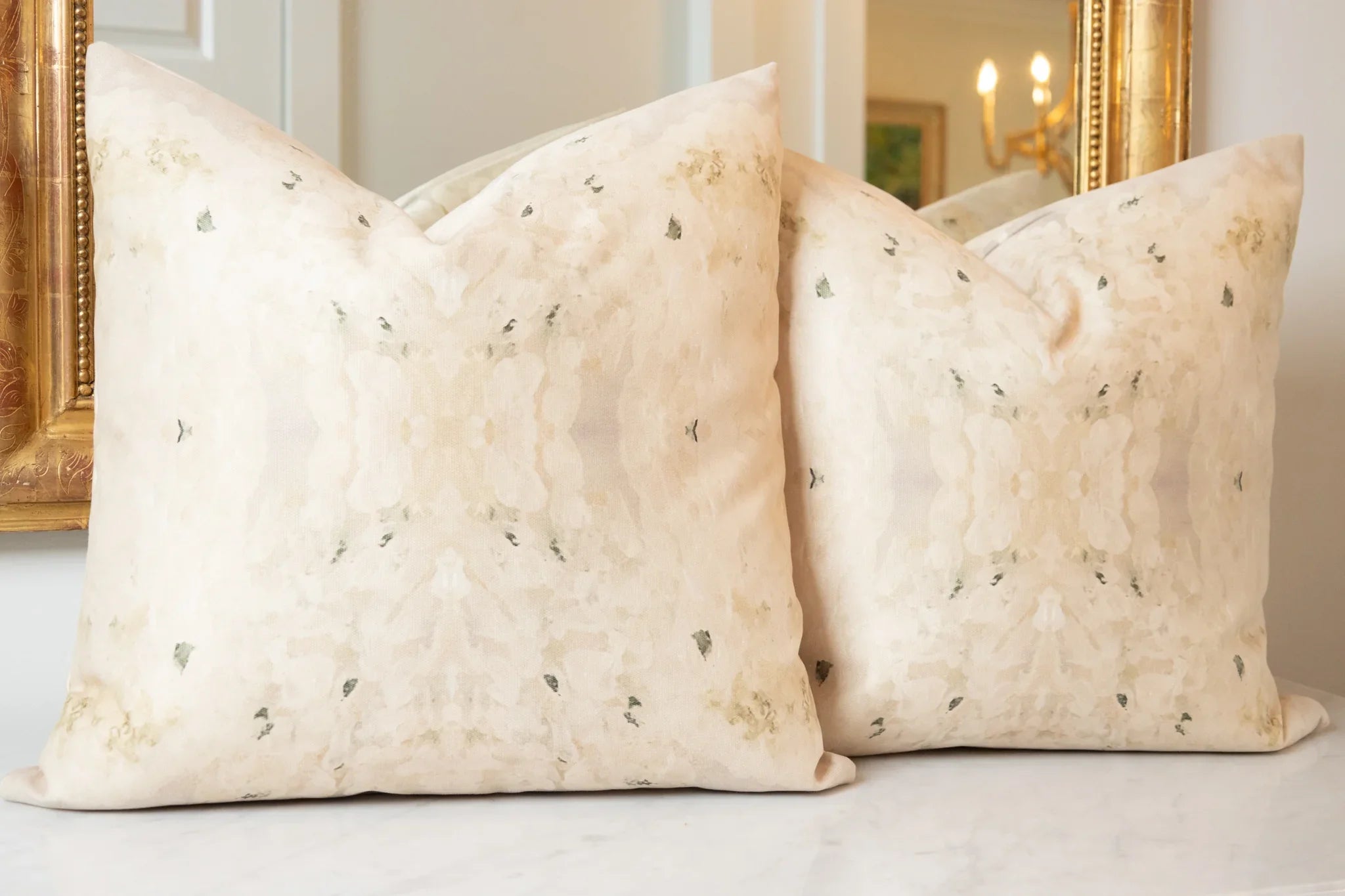 Centerpiece White Hydrangea luxury decorative pillow featuring a large-scale abstract floral pattern in layered white, cream, and deep olive green tones, handcrafted in England for luxury living rooms, designer-curated interiors, tailored upholstery, and thoughtfully layered homes.