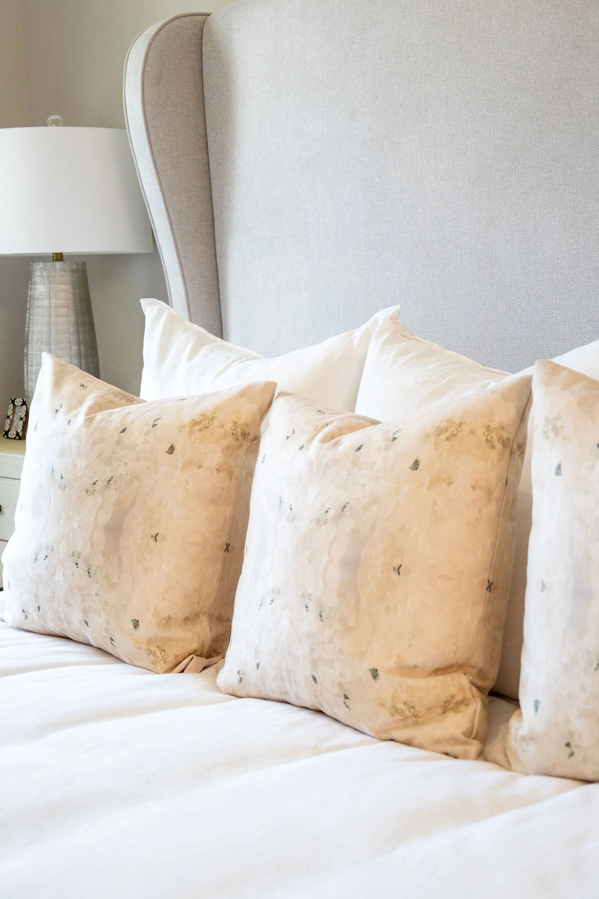 Centerpiece White Hydrangea luxury decorative pillow featuring a large-scale abstract floral pattern in layered white, cream, and deep olive green tones, handcrafted in England for luxury living rooms, designer-curated interiors, tailored upholstery, and thoughtfully layered homes.