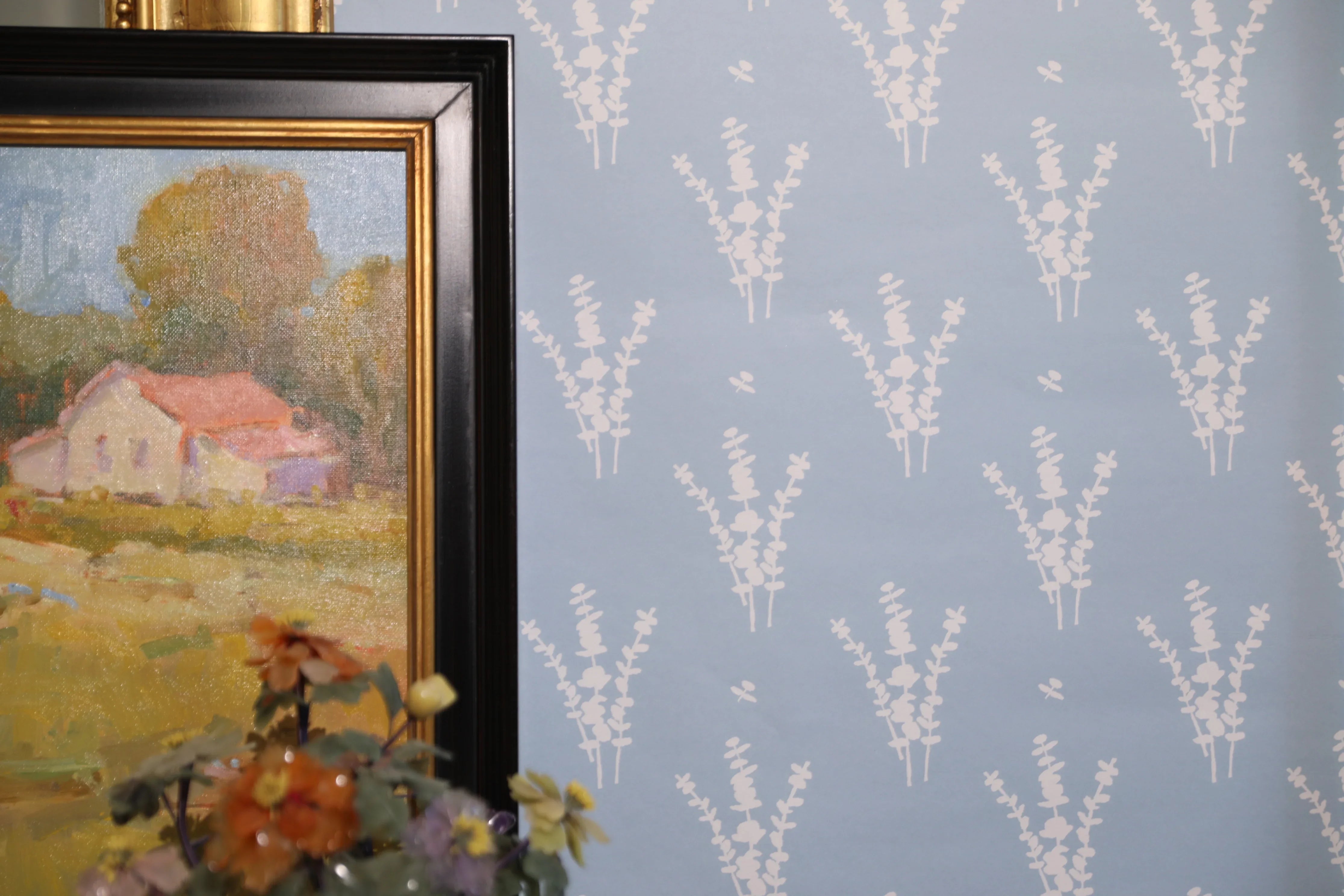 Luxury botanical wallpaper featuring a blue and white eucalyptus pattern, perfect for modern traditional interiors, coastal homes, powder rooms, bedrooms, and collected spaces.