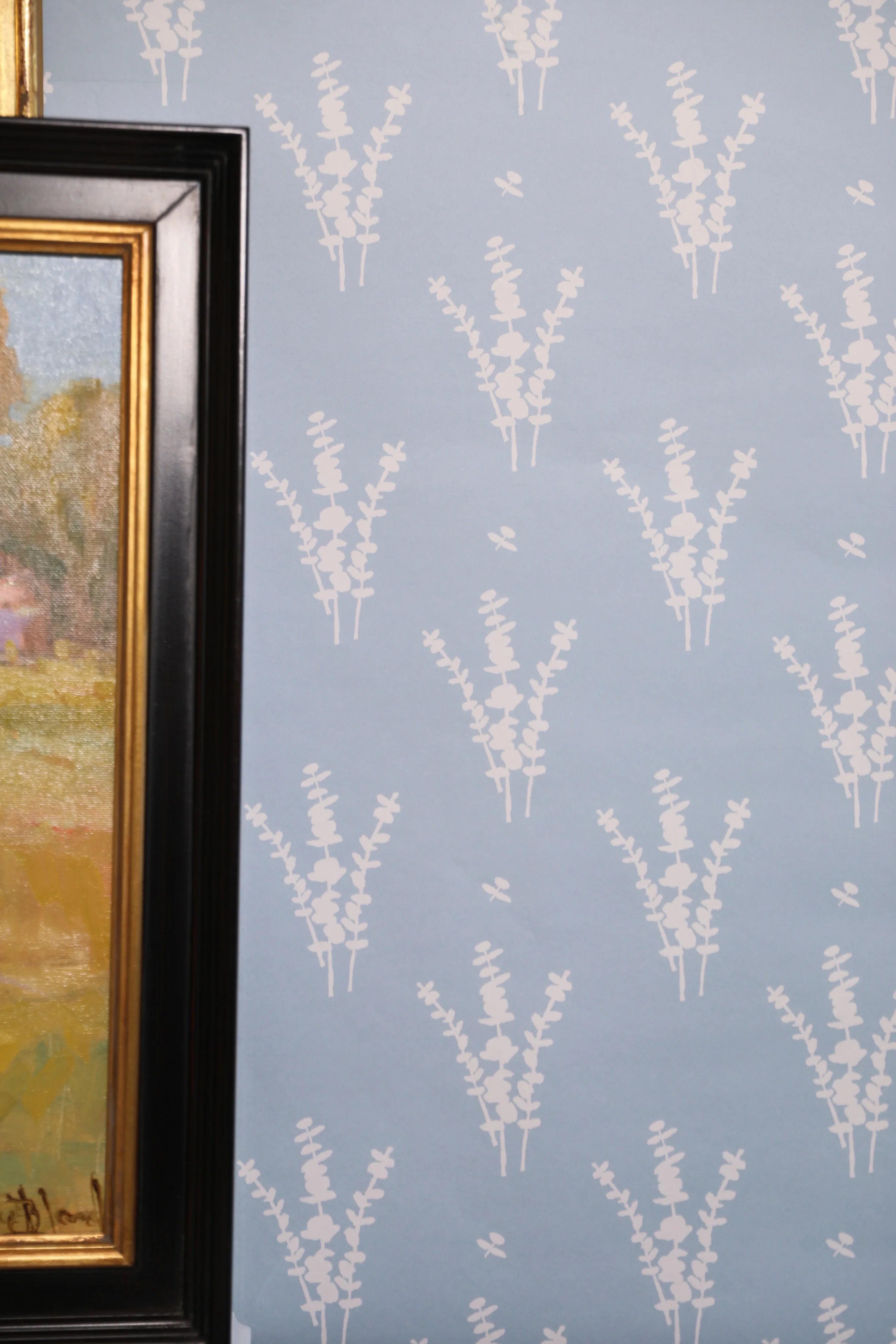 Luxury botanical wallpaper featuring a blue and white eucalyptus pattern, perfect for modern traditional interiors, coastal homes, powder rooms, bedrooms, and collected spaces.