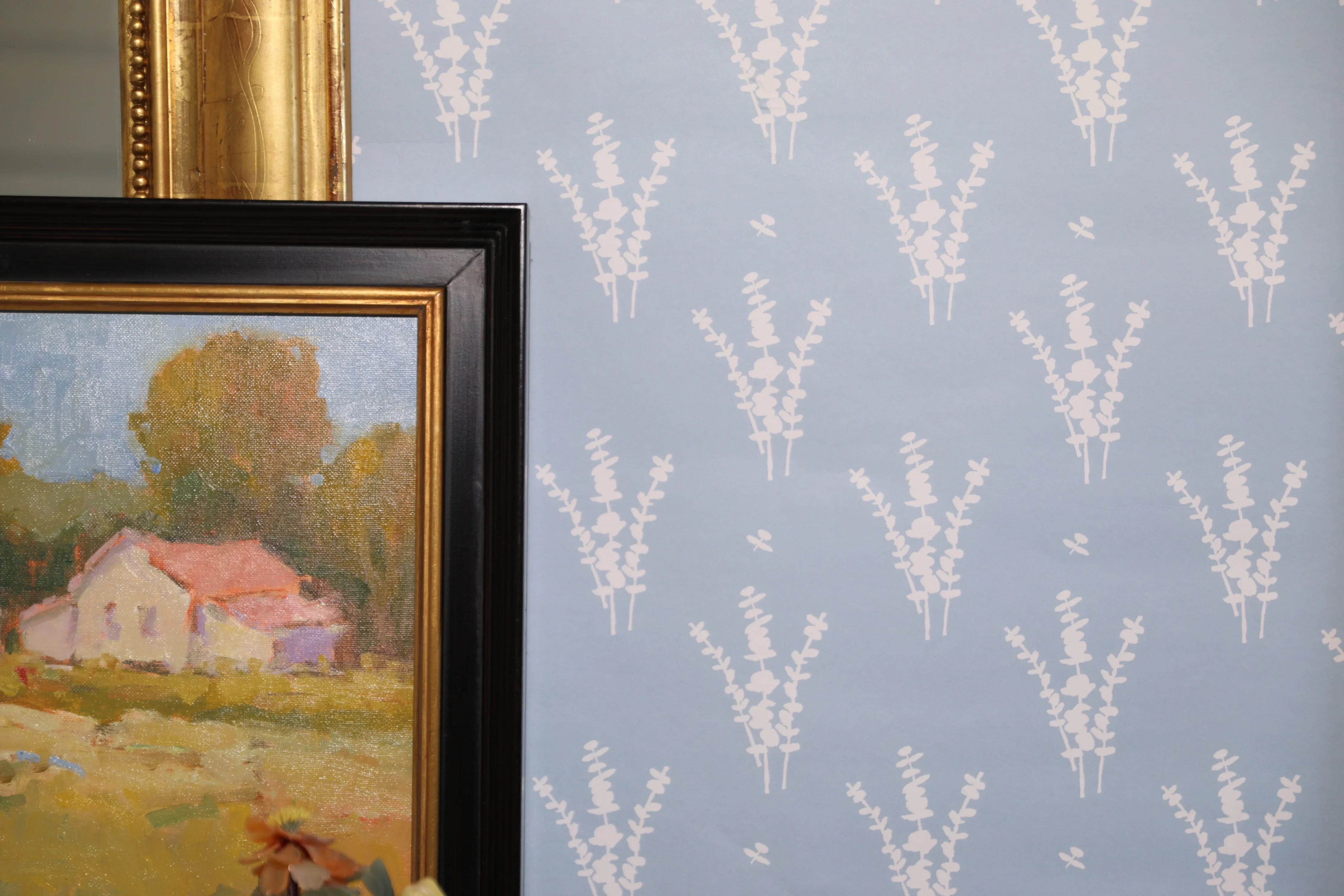 Luxury botanical wallpaper featuring a blue and white eucalyptus pattern, perfect for modern traditional interiors, coastal homes, powder rooms, bedrooms, and collected spaces.