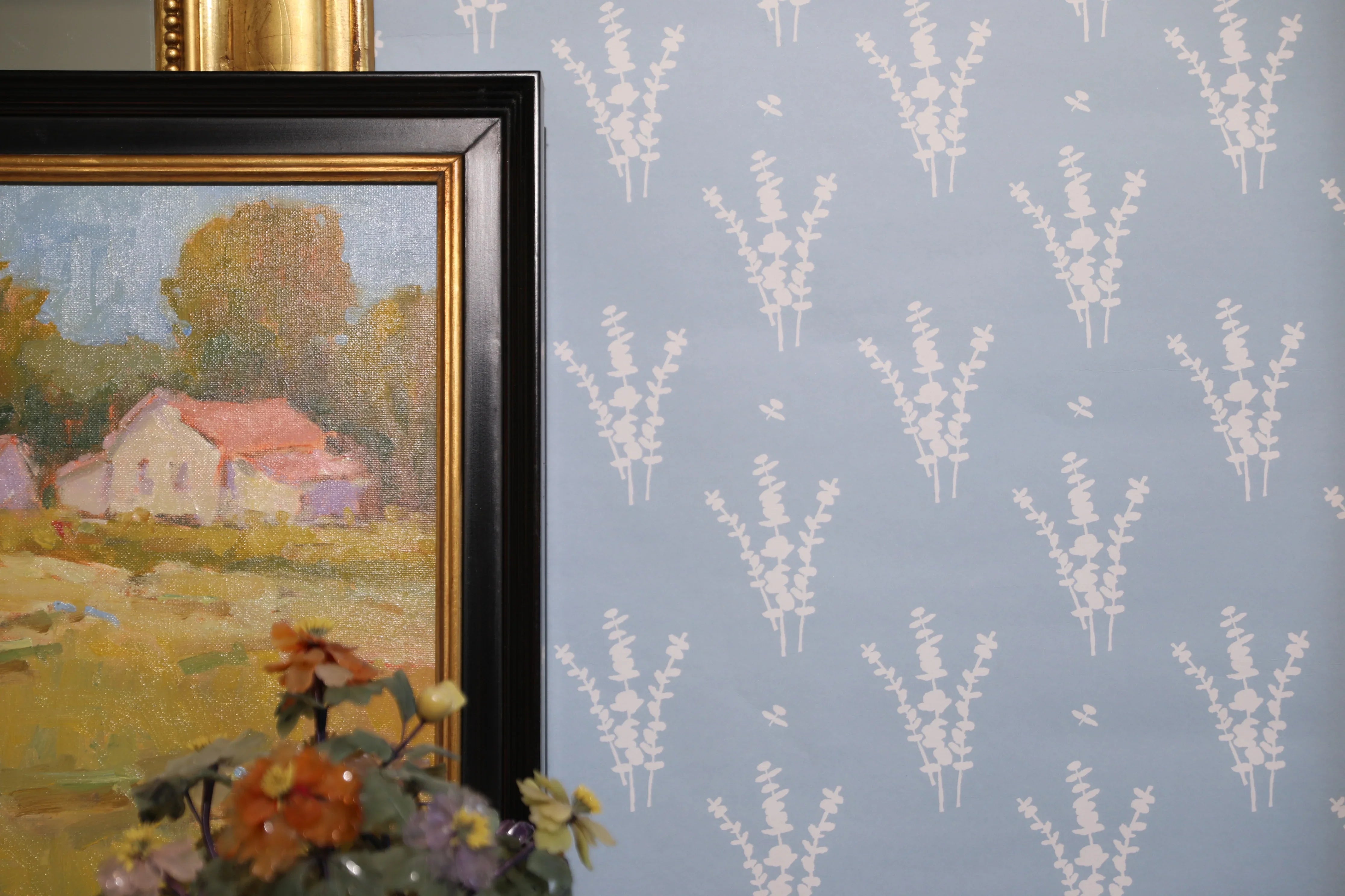 Luxury botanical wallpaper featuring a blue and white eucalyptus pattern, perfect for modern traditional interiors, coastal homes, powder rooms, bedrooms, and collected spaces.