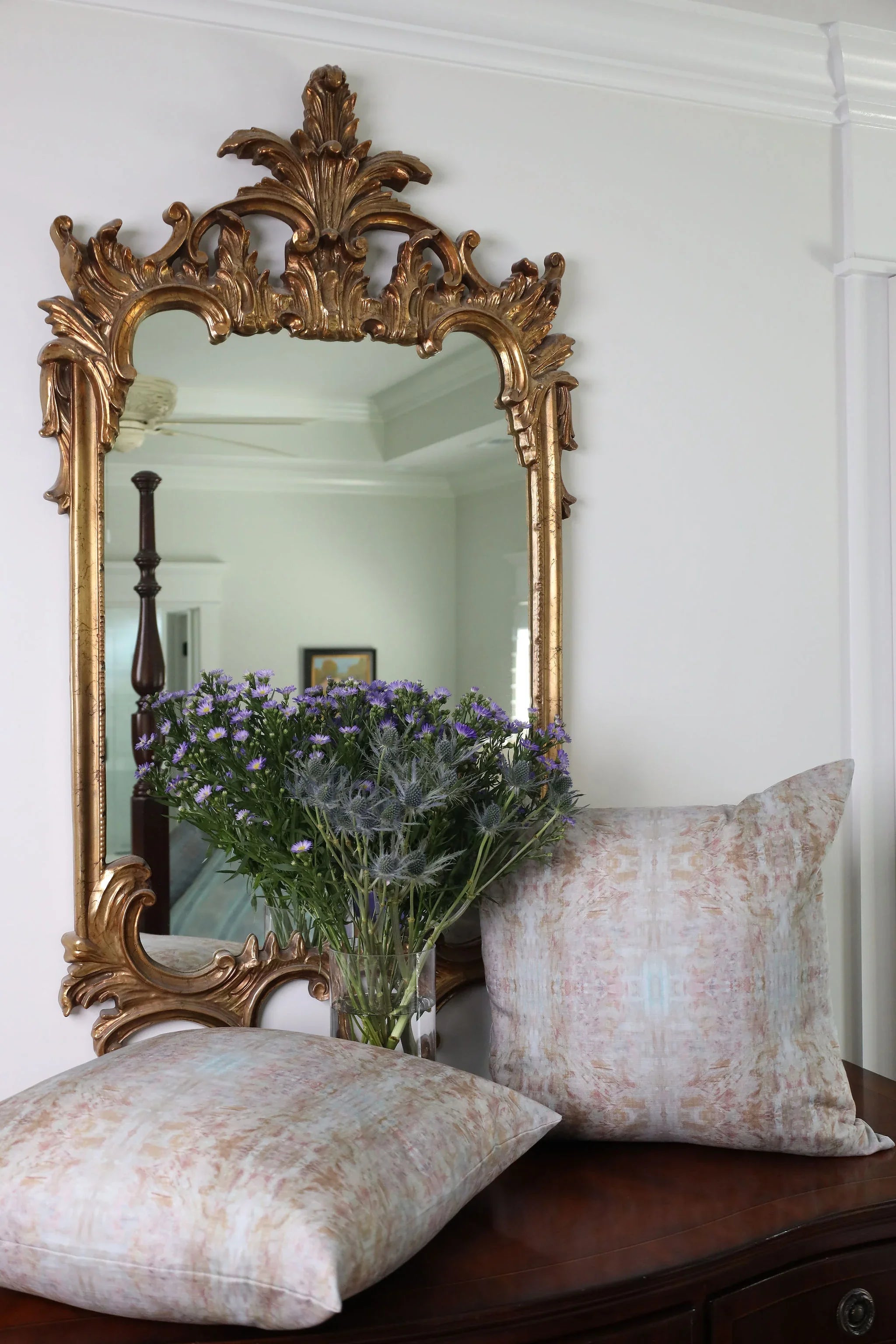 The Gardens Bronze Iris luxury decorative pillow featuring an abstract floral pattern with layered artistic movement and rich bronze, plum, and earthy tones, handcrafted in England for luxury living rooms, designer-curated interiors, thoughtfully layered spaces, and modern traditional homes.