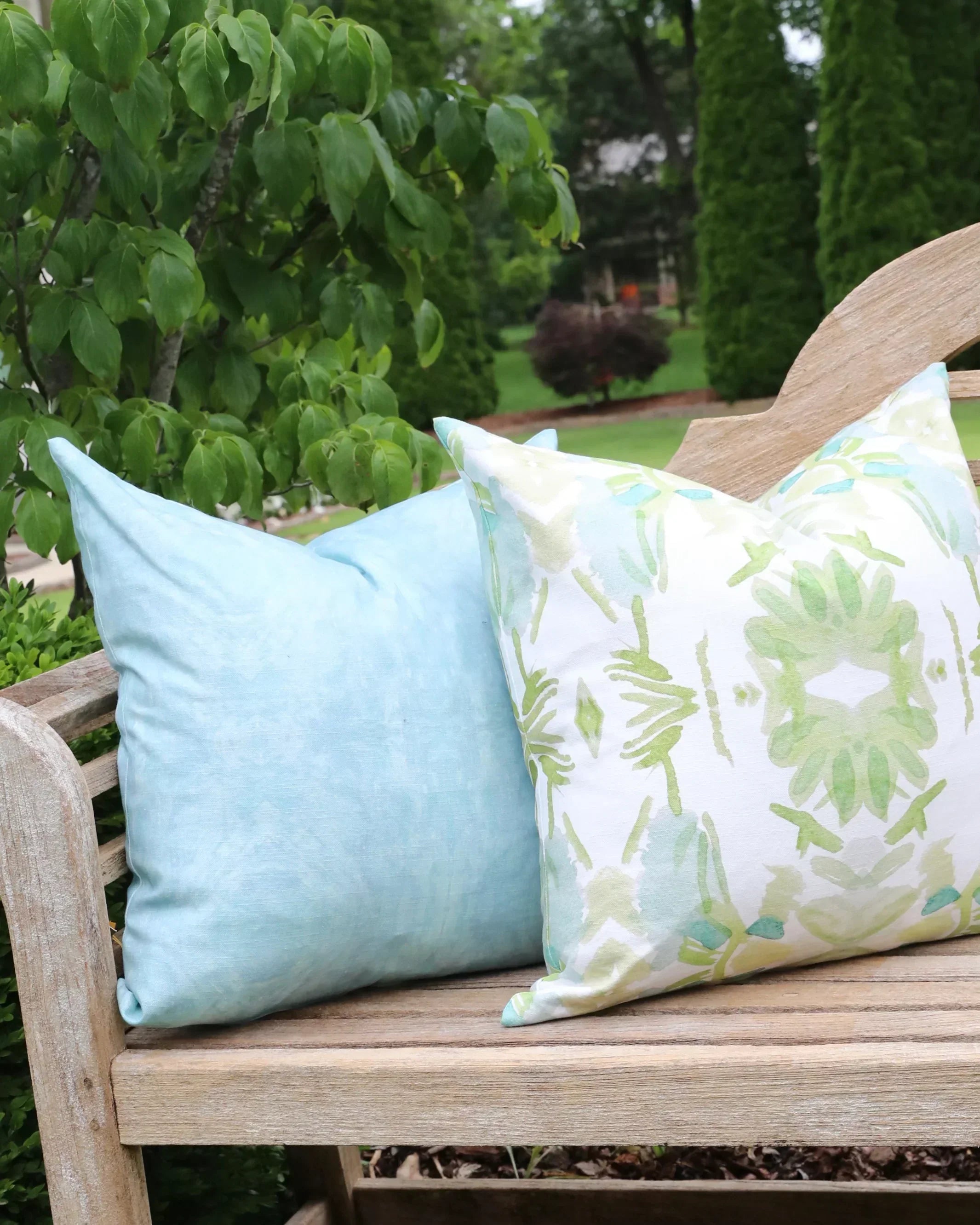 Luxury white and apple green botanical pillow with large-scale floral pattern inspired by Alaska wildflowers, handcrafted in England for contemporary and traditional interiors.
