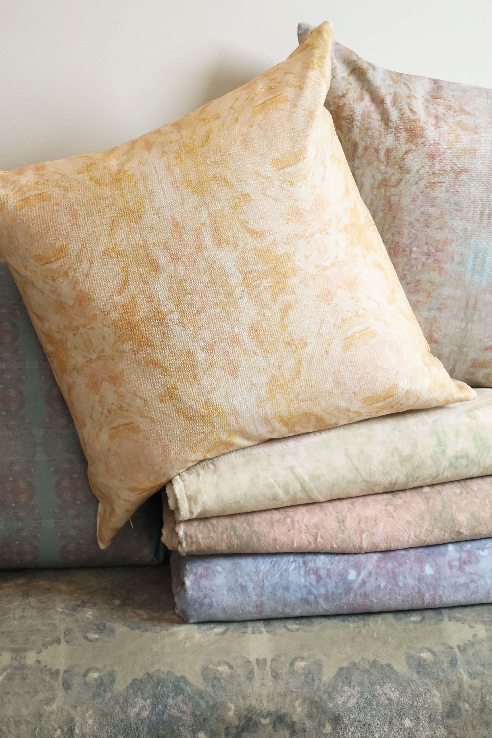 Luxury decorative pillow featuring an abstract topiary-inspired pattern in warm autumn gold and neutral tones, styled for a layered modern traditional interior.