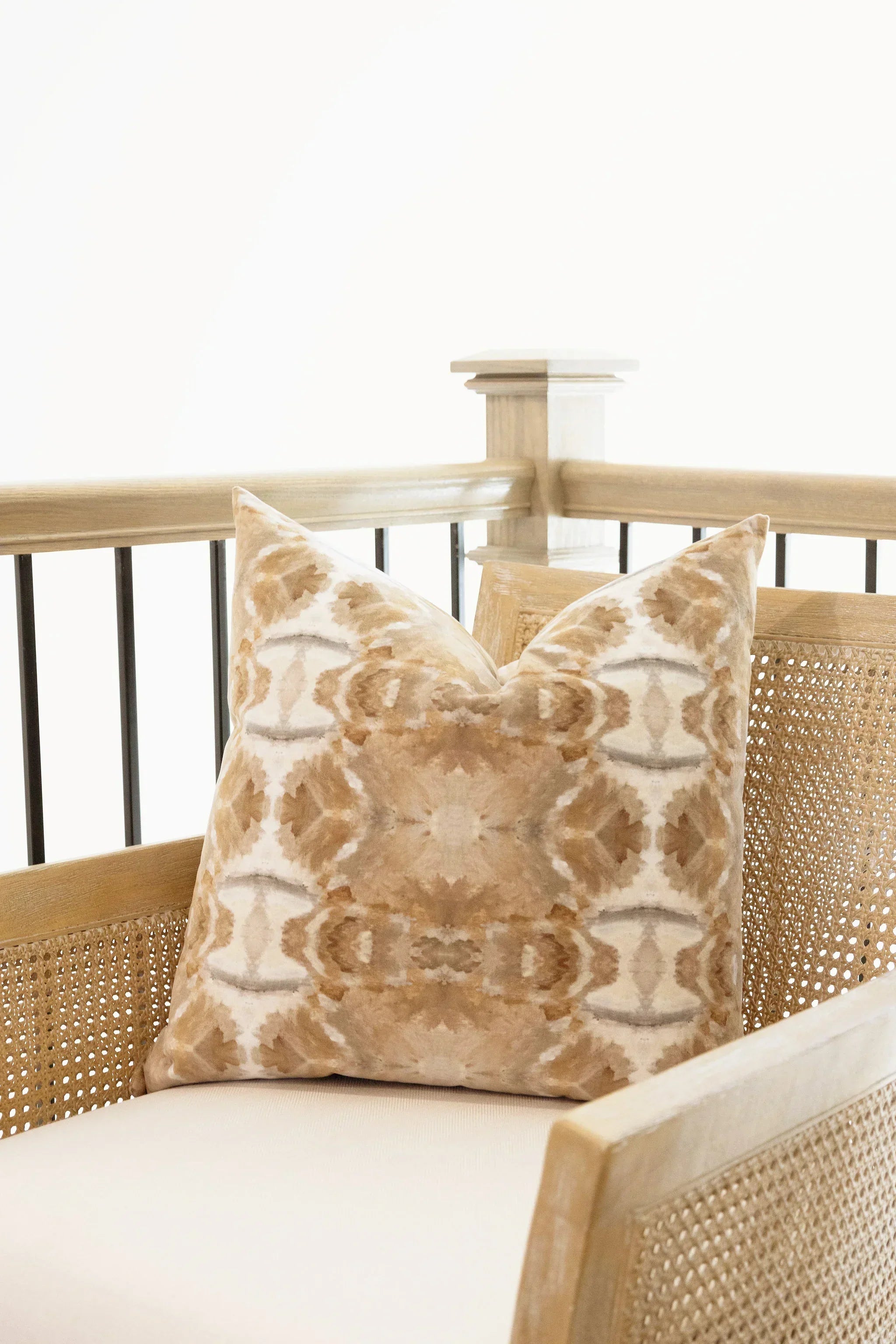 Luxury decorative pillow featuring an organic tree-inspired pattern in warm cognac and neutral tones, styled for a layered modern traditional interior.