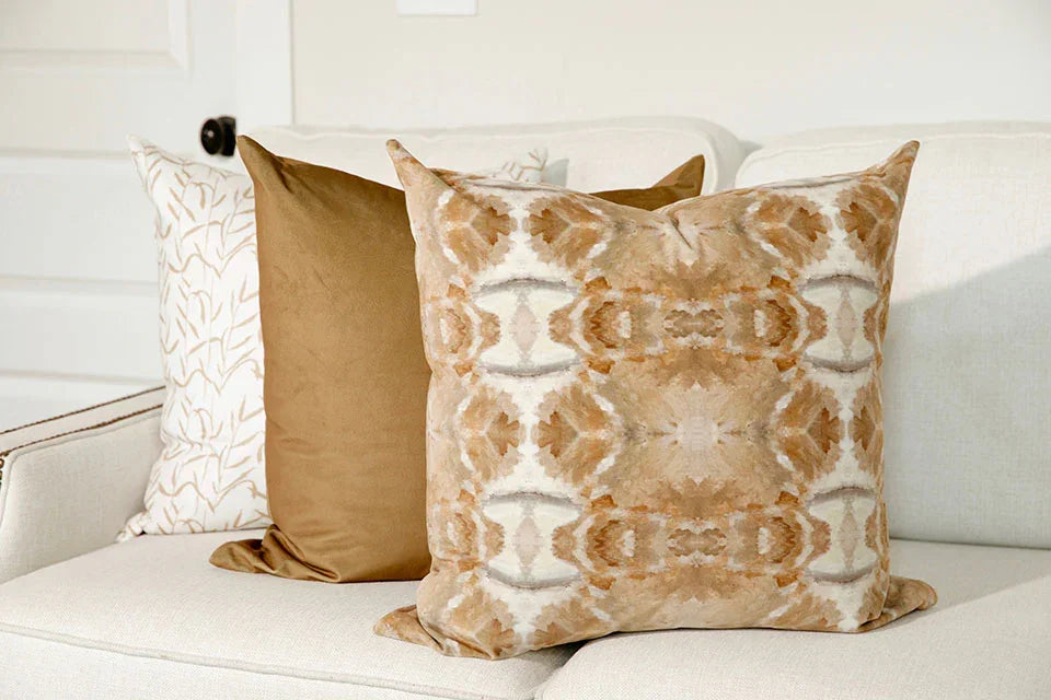 Luxury decorative pillow featuring an organic tree-inspired pattern in warm cognac and neutral tones, styled for a layered modern traditional interior.