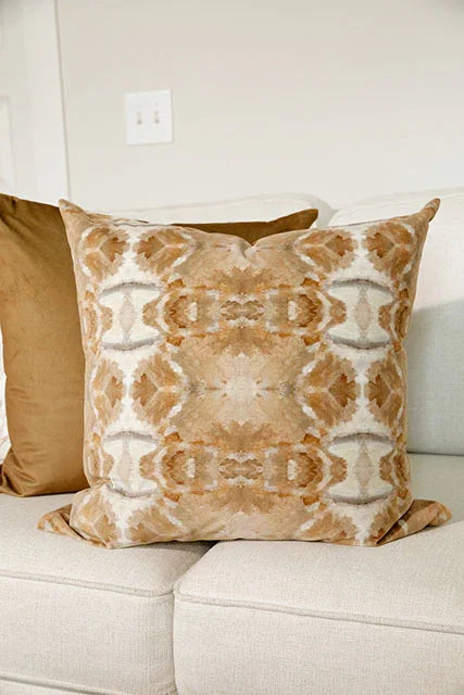 Luxury decorative pillow featuring an organic tree-inspired pattern in warm cognac and neutral tones, styled for a layered modern traditional interior.