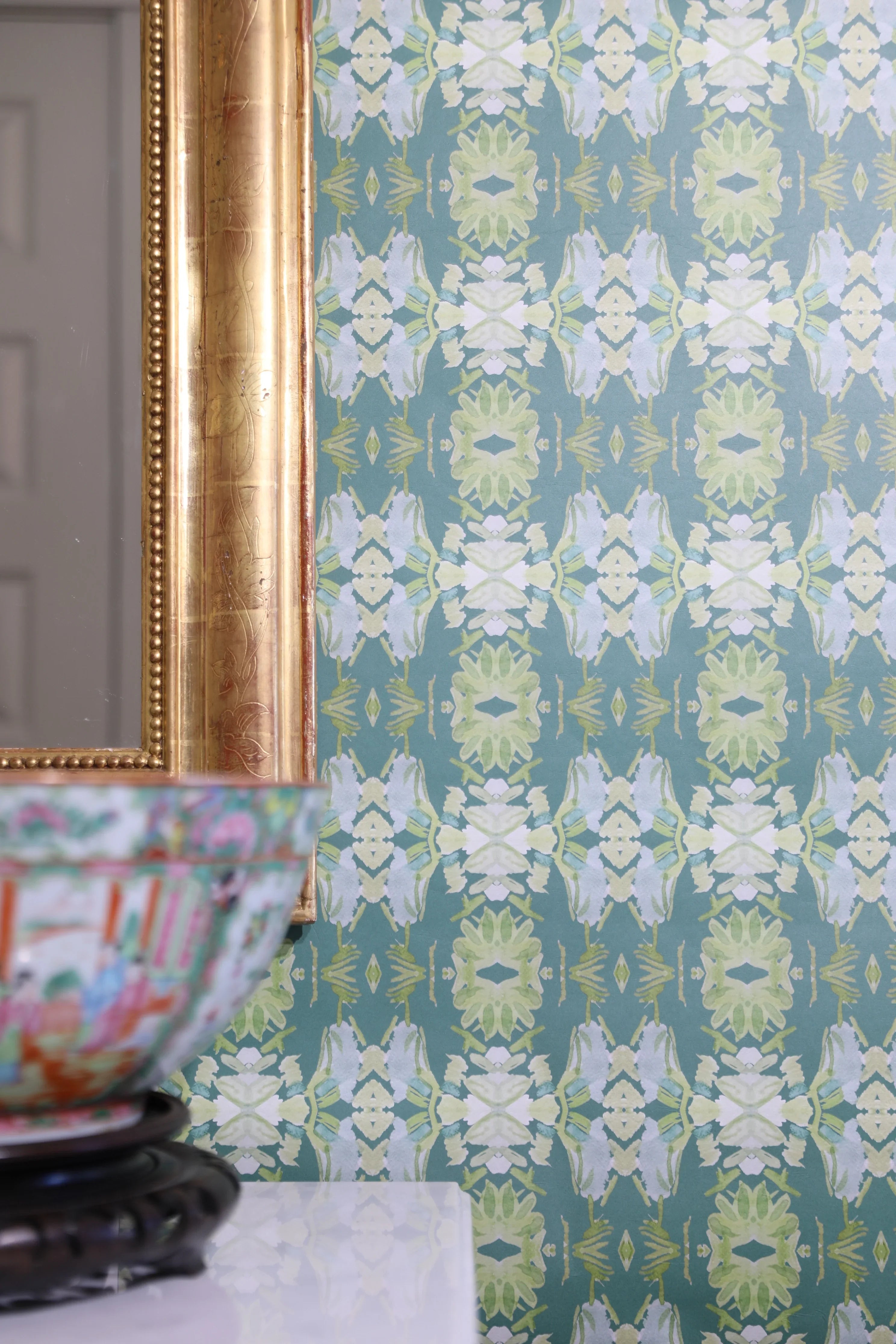 Luxury abstract floral wallpaper in rich dark green tones with layered organic movement, designed for modern traditional and collected interiors.