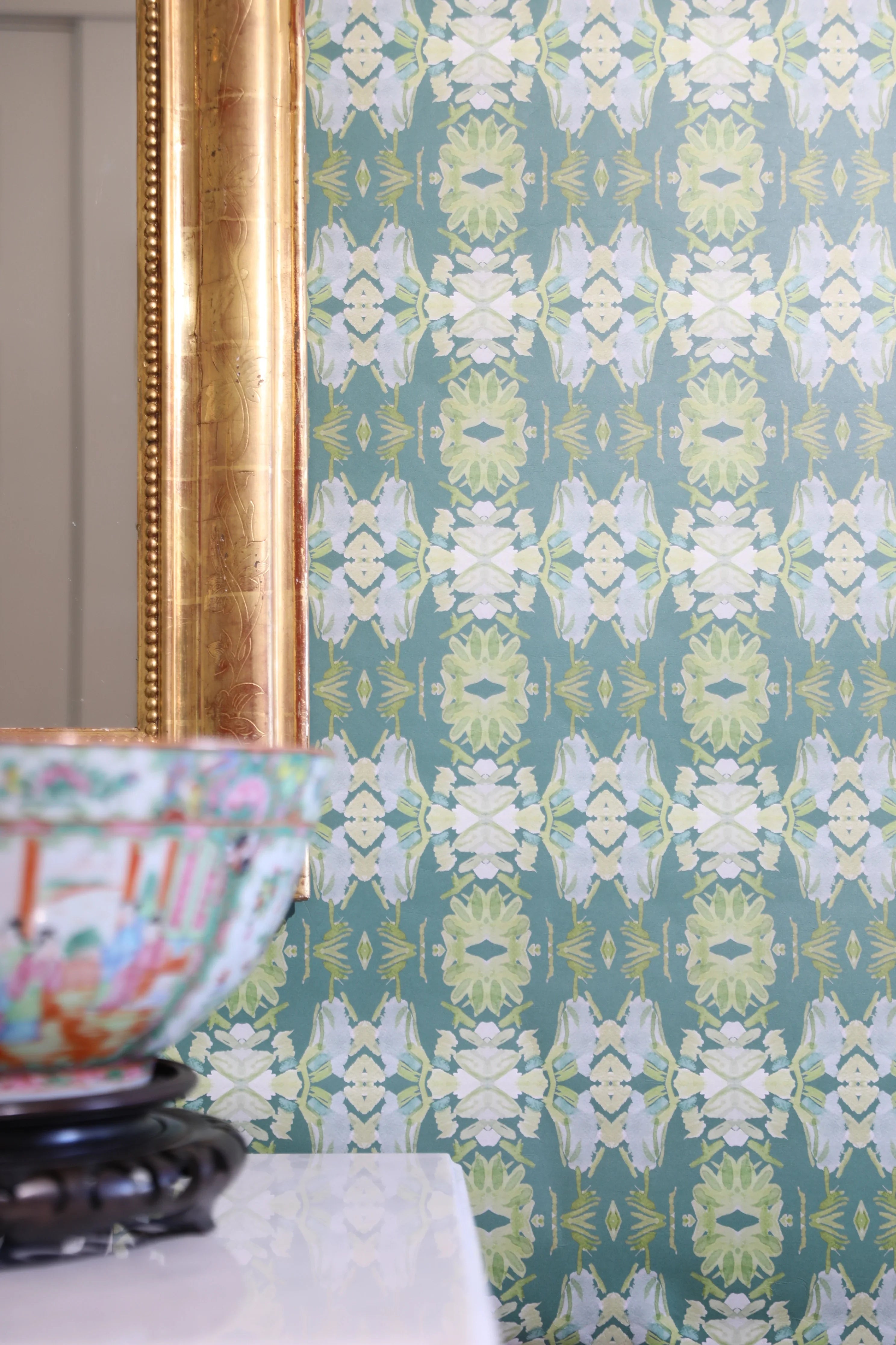 Luxury abstract floral wallpaper in rich dark green tones with layered organic movement, designed for modern traditional and collected interiors.