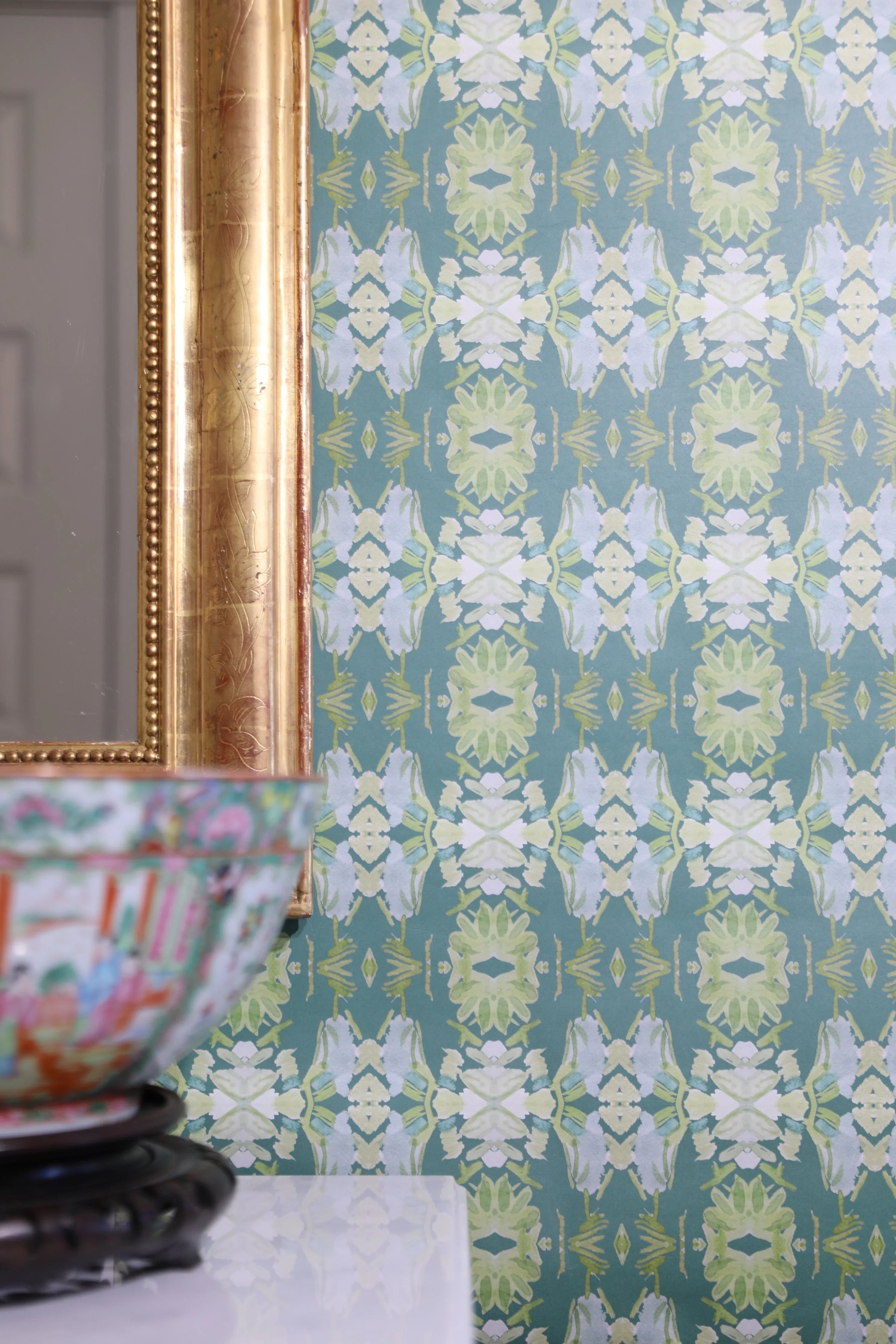 Luxury abstract floral wallpaper in rich dark green tones with layered organic movement, designed for modern traditional and collected interiors.