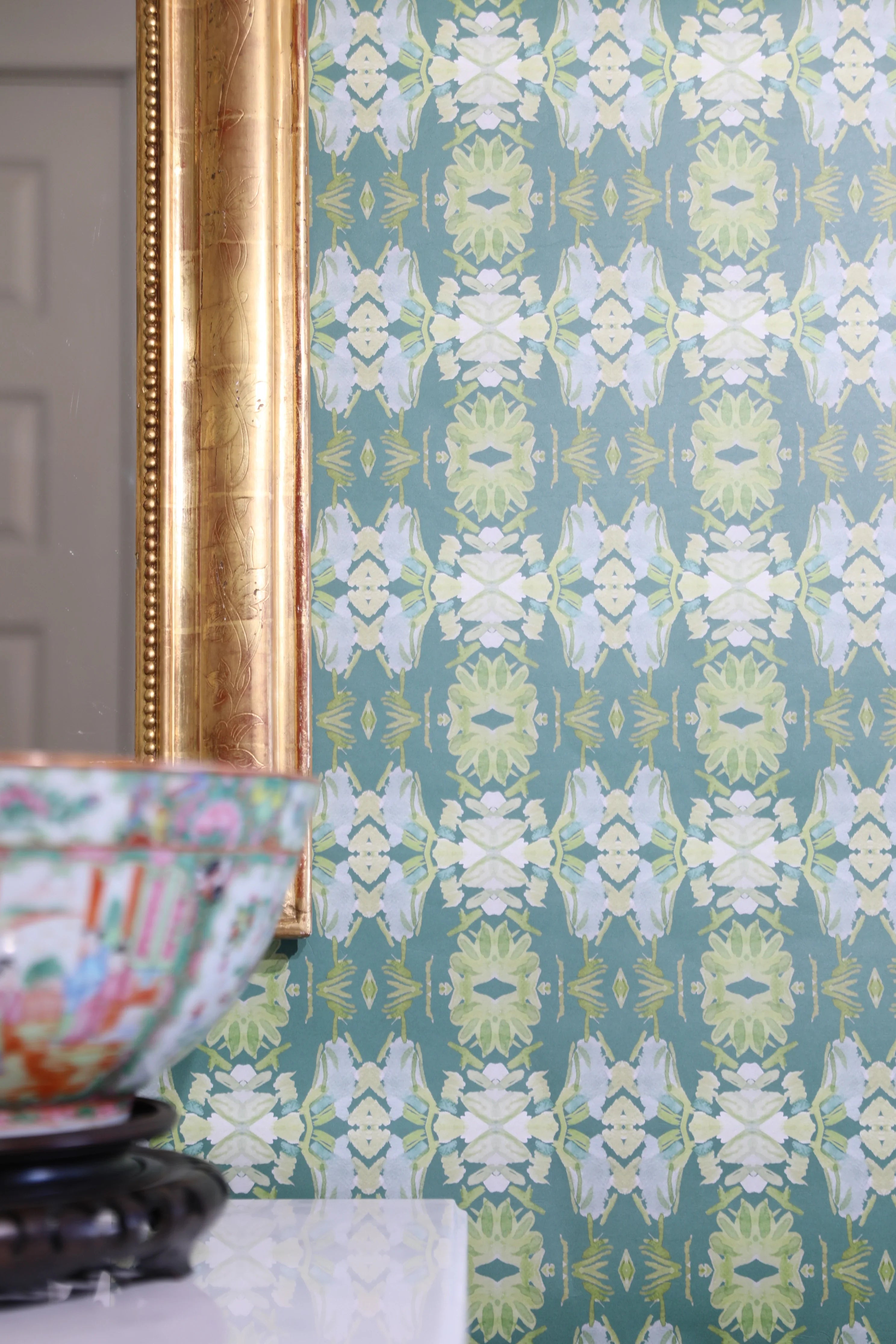 Luxury abstract floral wallpaper in rich dark green tones with layered organic movement, designed for modern traditional and collected interiors.
