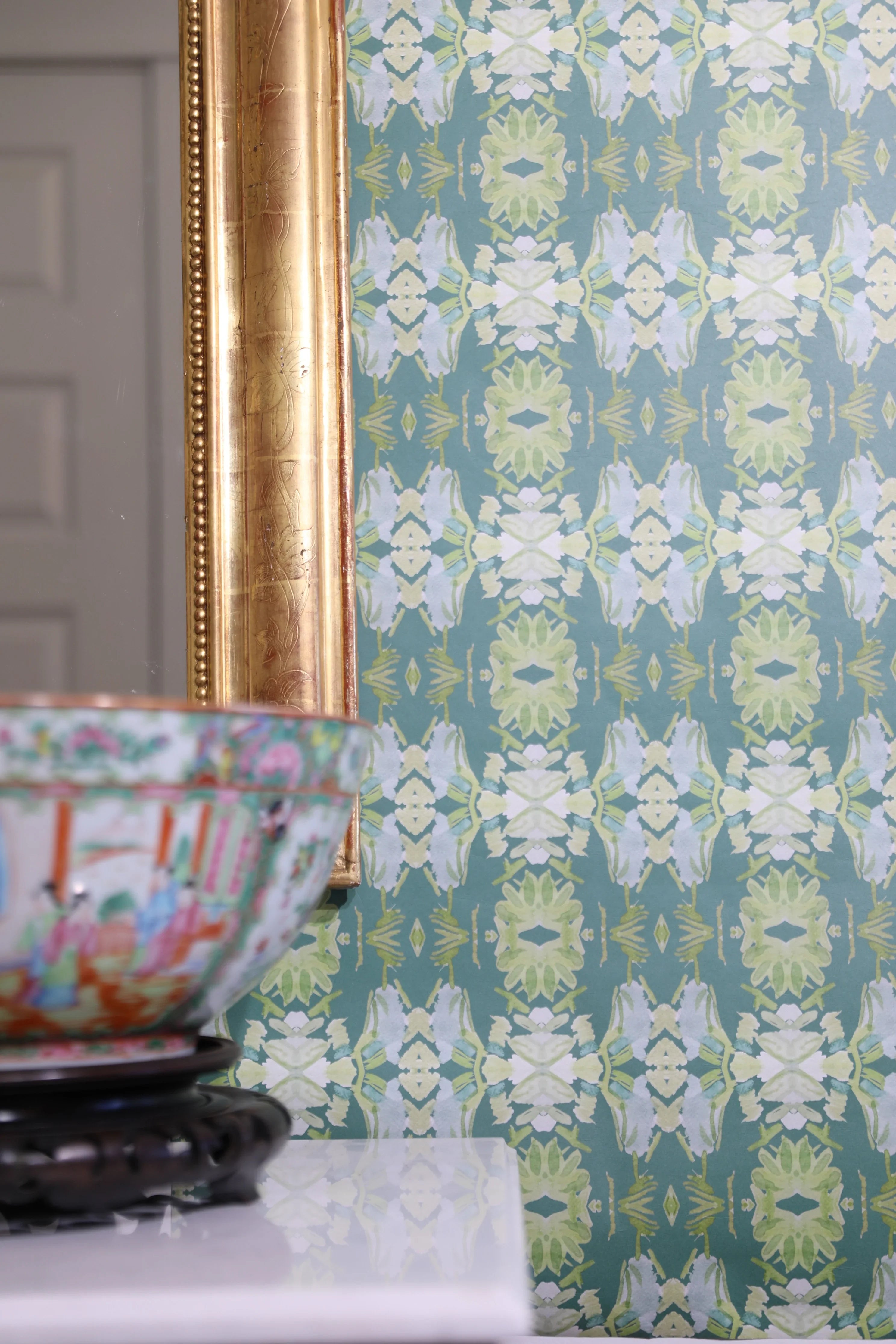 Luxury abstract floral wallpaper in rich dark green tones with layered organic movement, designed for modern traditional and collected interiors.