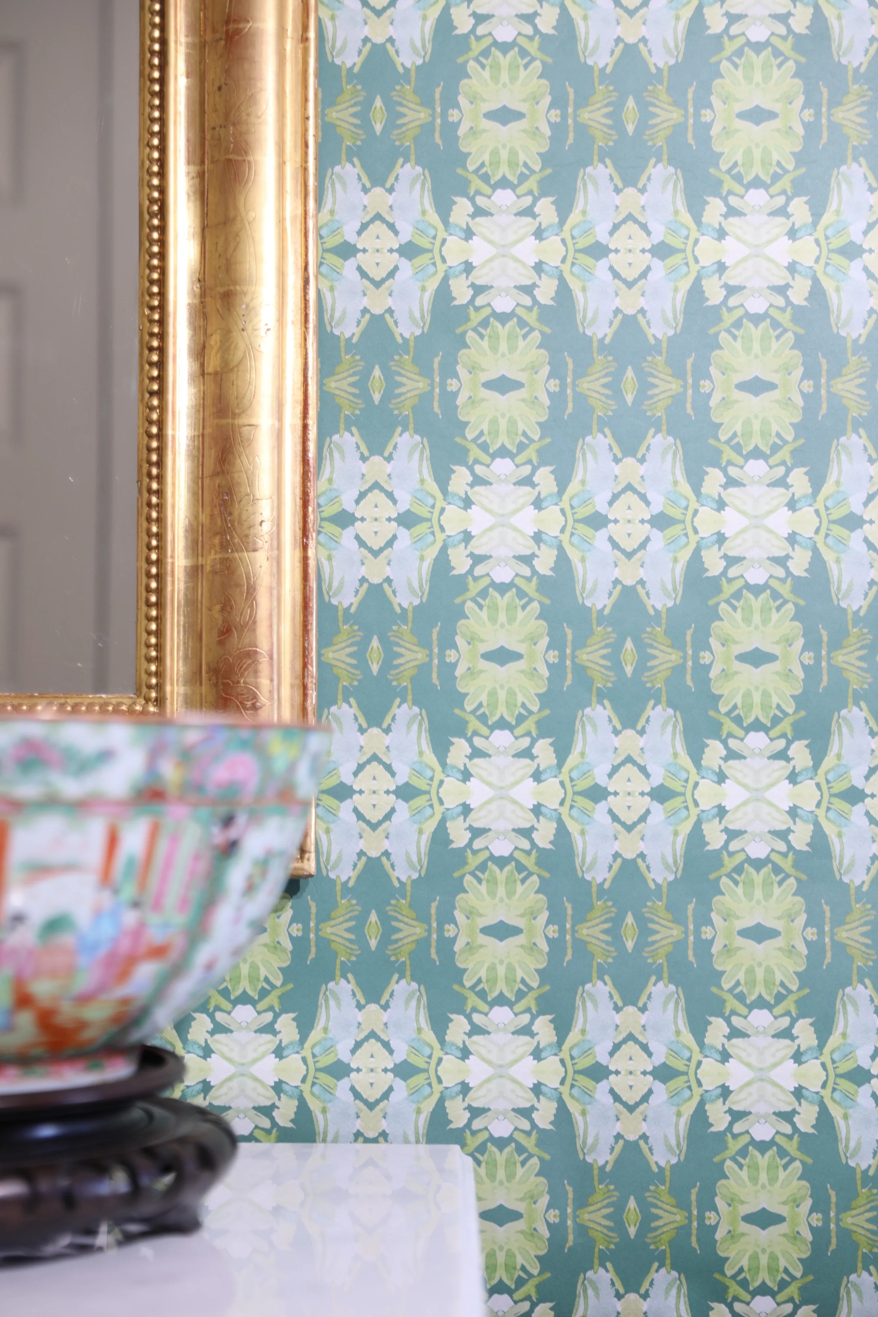 Luxury abstract floral wallpaper in rich dark green tones with layered organic movement, designed for modern traditional and collected interiors.