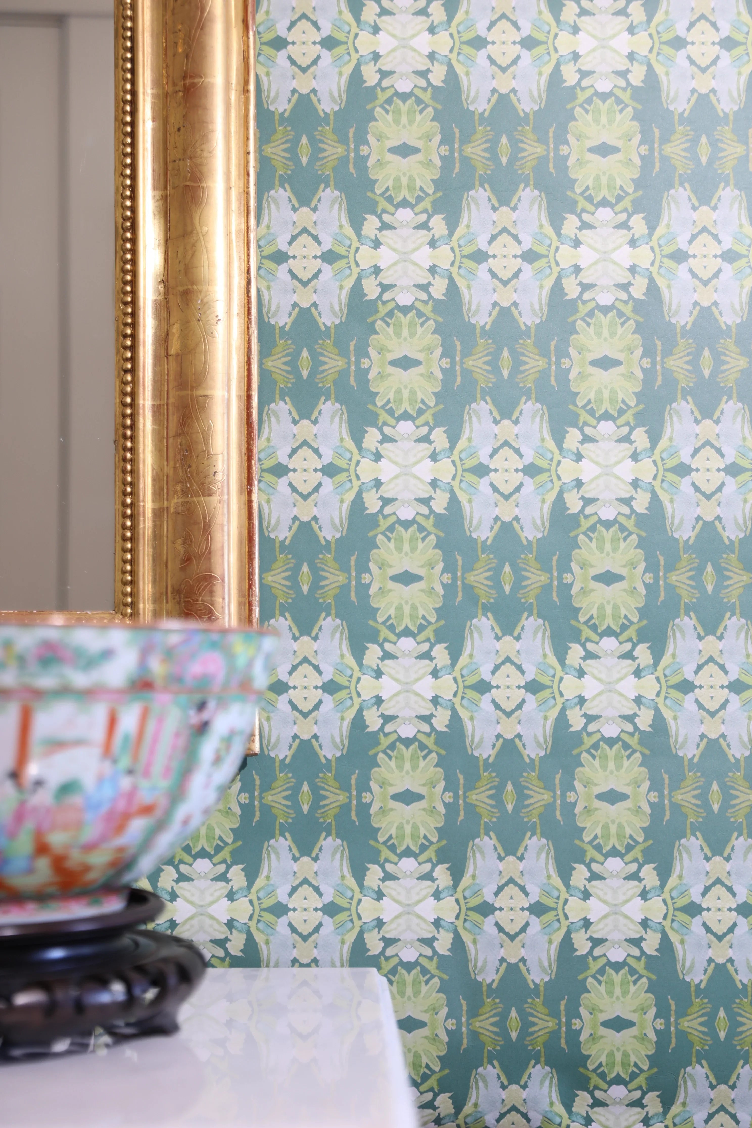 Luxury abstract floral wallpaper in rich dark green tones with layered organic movement, designed for modern traditional and collected interiors.