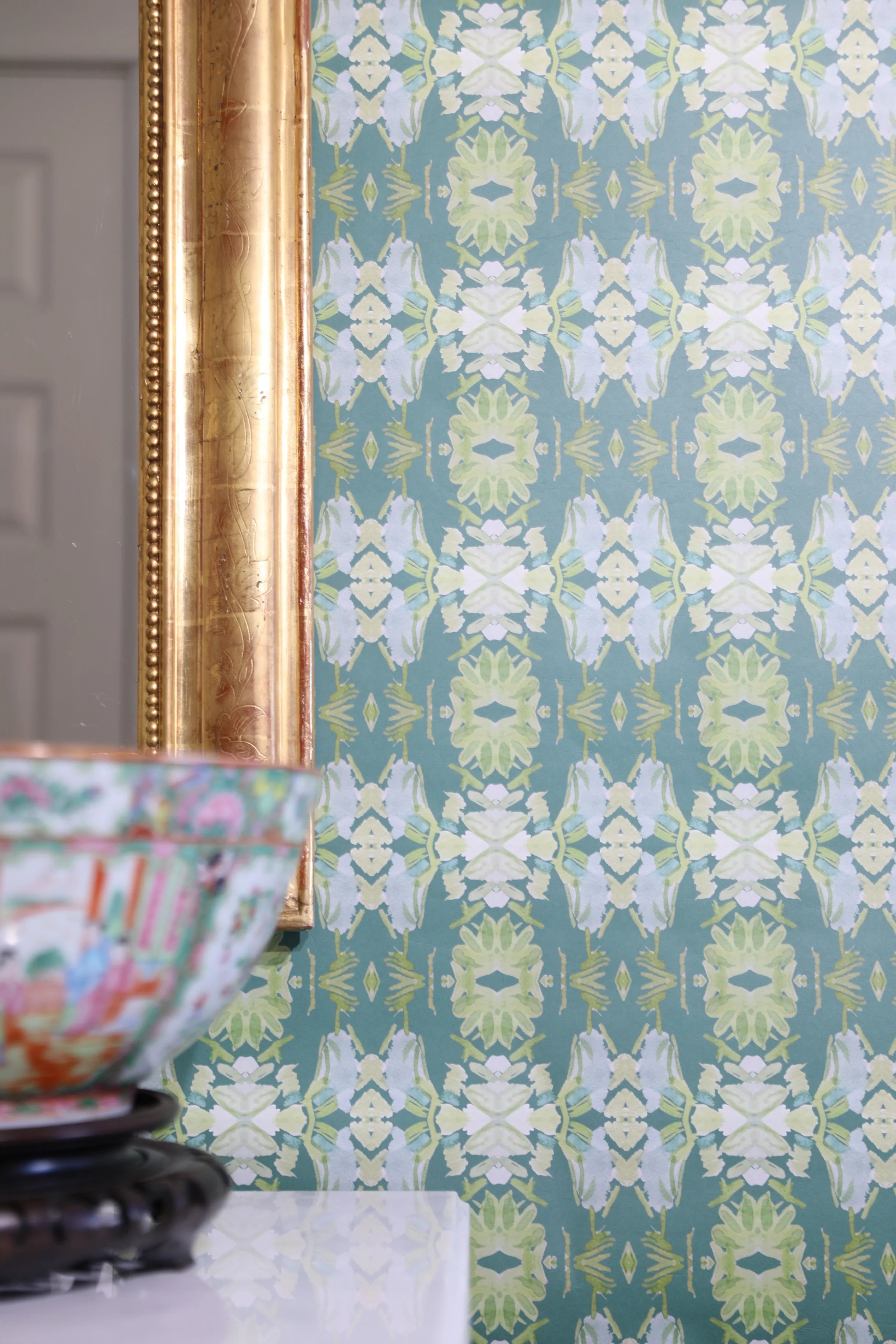 Luxury abstract floral wallpaper in rich dark green tones with layered organic movement, designed for modern traditional and collected interiors.