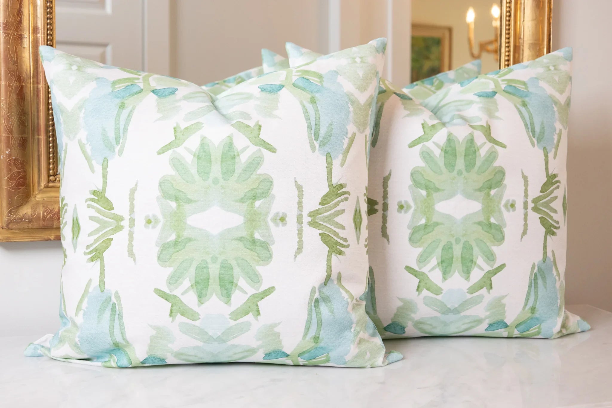 Luxury sage green and powder blue botanical pillow with large-scale floral pattern inspired by Alaska wildflowers, handcrafted in England and styled for contemporary and traditional interiors.