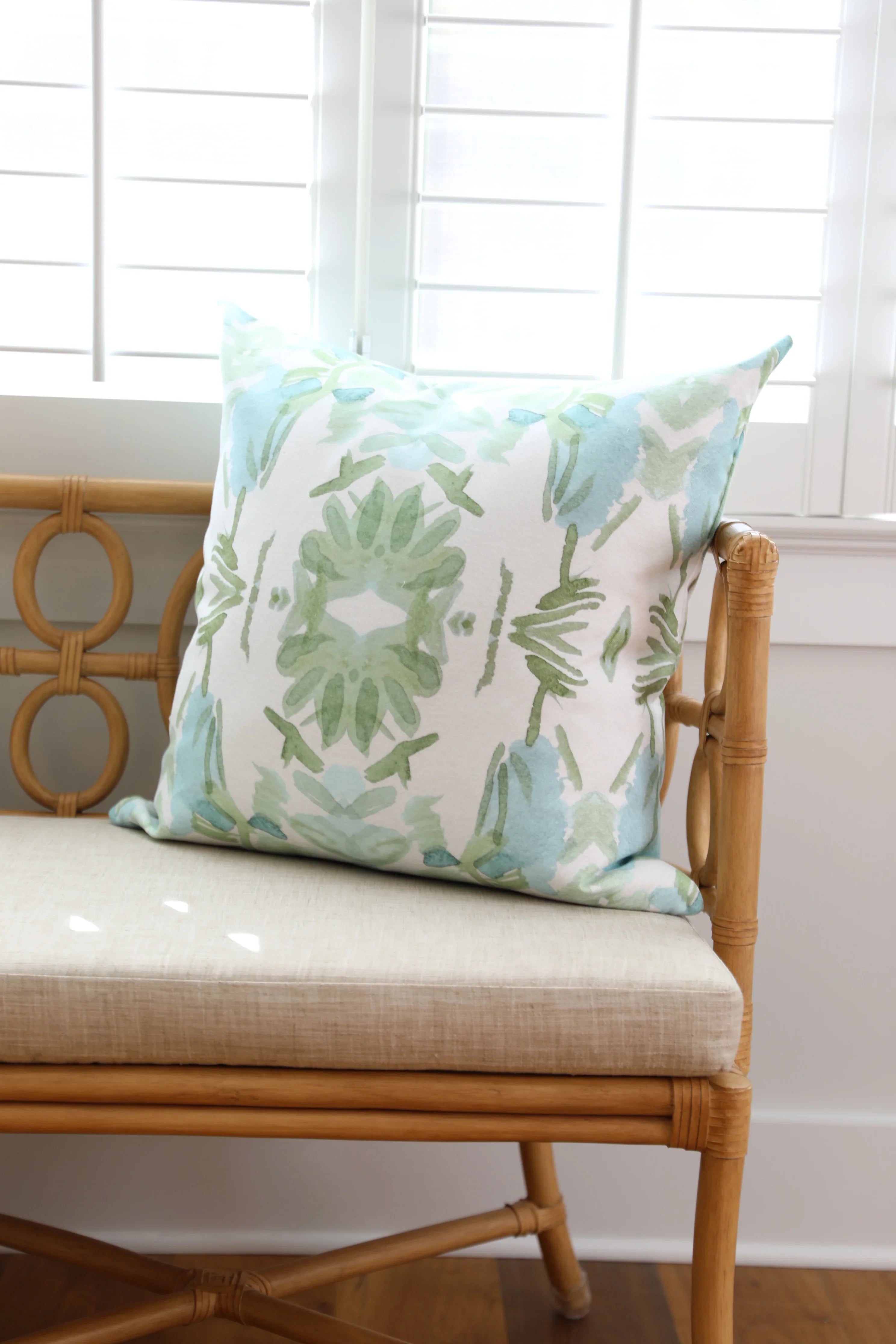 Luxury sage green and powder blue botanical pillow with large-scale floral pattern inspired by Alaska wildflowers, handcrafted in England and styled for contemporary and traditional interiors.