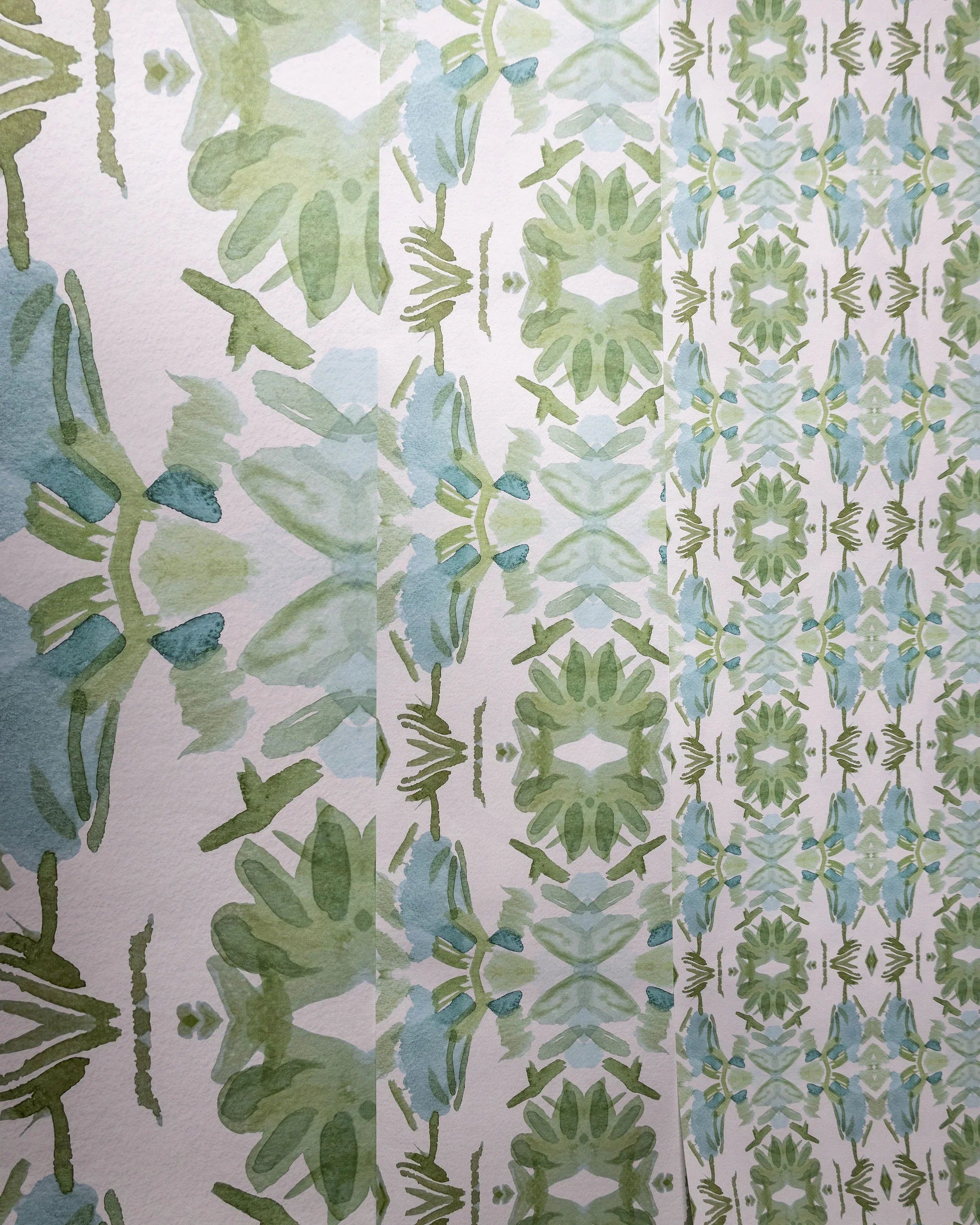 Luxury botanical wallpaper featuring an artistic wildflower-inspired pattern in sage green and soft blue, designed for modern traditional interiors, powder rooms, bedrooms, dining rooms, and collected homes.