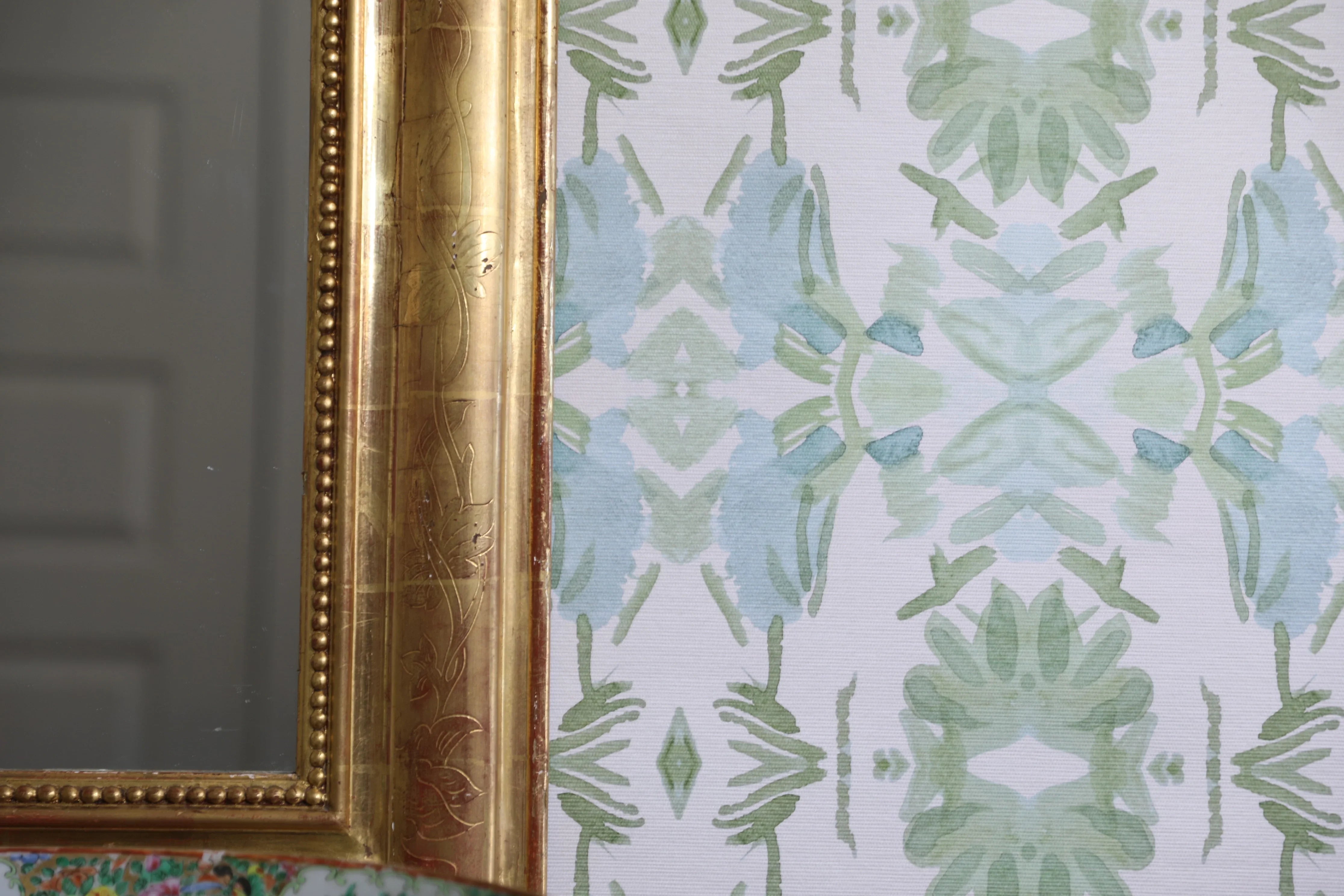 Luxury botanical wallpaper featuring an artistic wildflower-inspired pattern in sage green and soft blue, designed for modern traditional interiors, powder rooms, bedrooms, dining rooms, and collected homes.