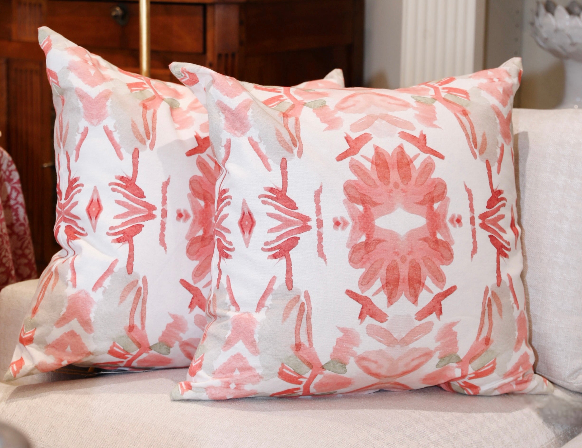 Wildflowers I Strawberry luxury decorative pillow featuring a large-scale abstract floral pattern in rich strawberry pink and red tones, handcrafted in England for luxury living rooms, designer-curated interiors, layered bedrooms, and modern traditional homes.