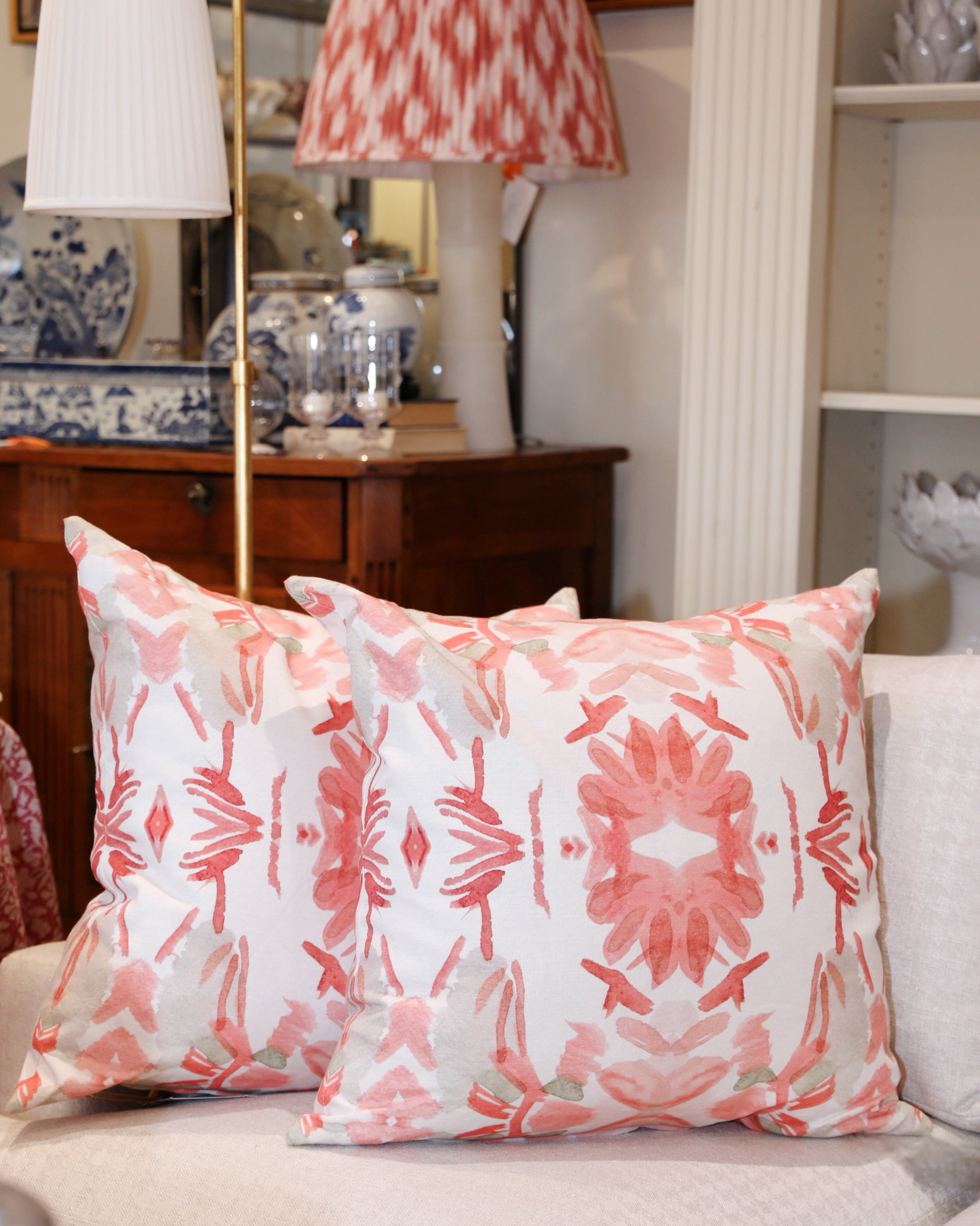 Wildflowers I Strawberry luxury decorative pillow featuring a large-scale abstract floral pattern in rich strawberry pink and red tones, handcrafted in England for luxury living rooms, designer-curated interiors, layered bedrooms, and modern traditional homes.