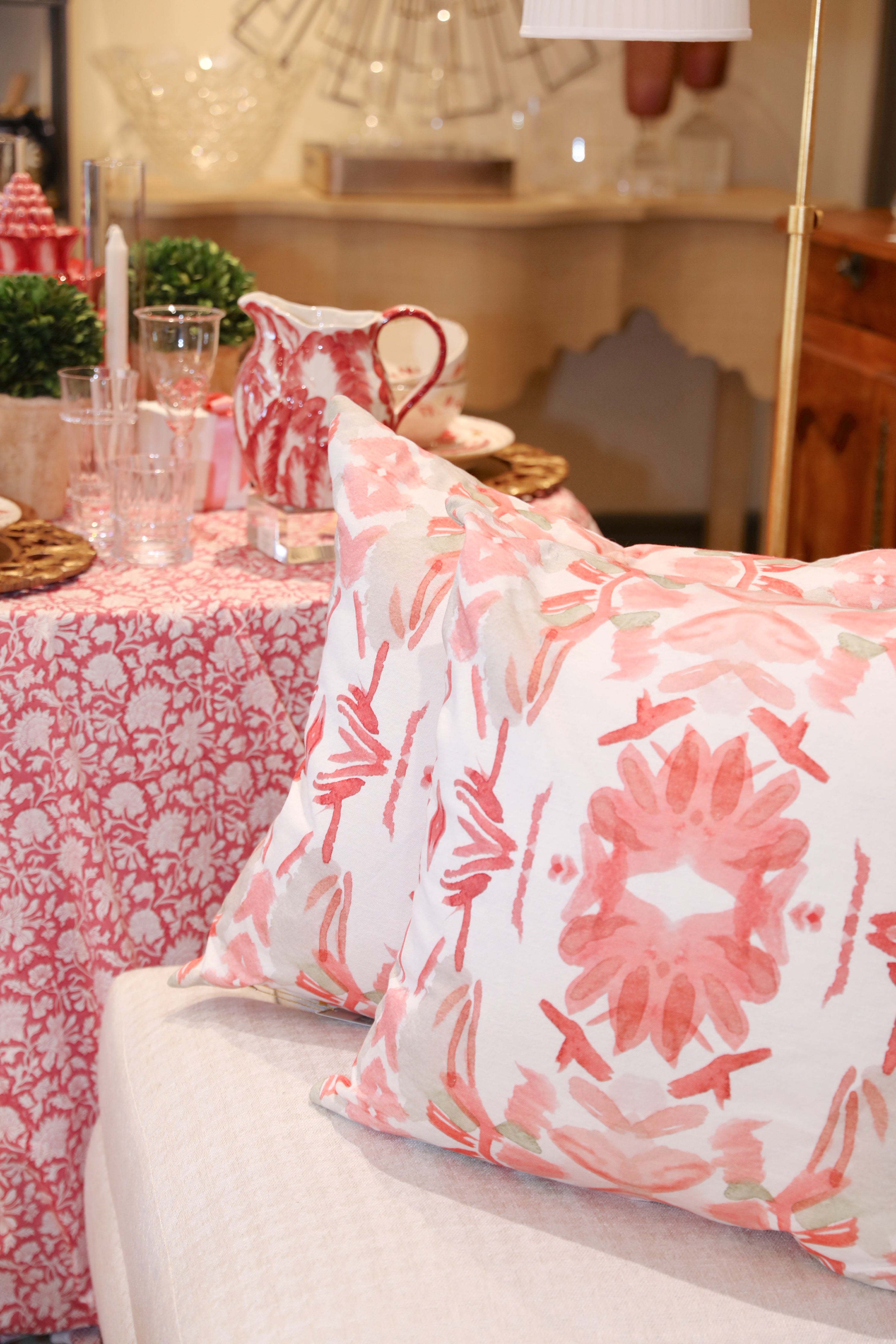 Wildflowers I Strawberry luxury decorative pillow featuring a large-scale abstract floral pattern in rich strawberry pink and red tones, handcrafted in England for luxury living rooms, designer-curated interiors, layered bedrooms, and modern traditional homes.