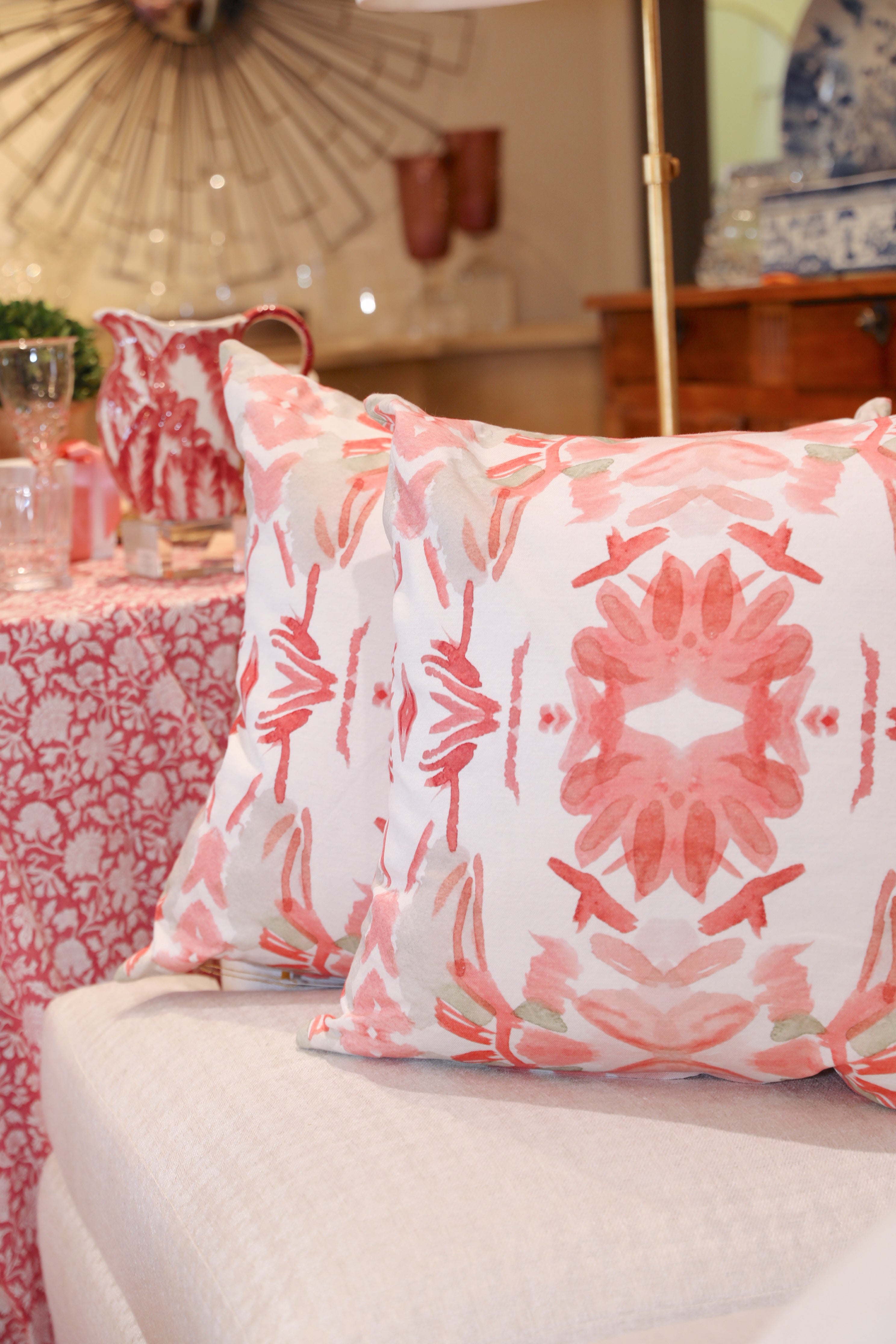 Wildflowers I Strawberry luxury decorative pillow featuring a large-scale abstract floral pattern in rich strawberry pink and red tones, handcrafted in England for luxury living rooms, designer-curated interiors, layered bedrooms, and modern traditional homes.