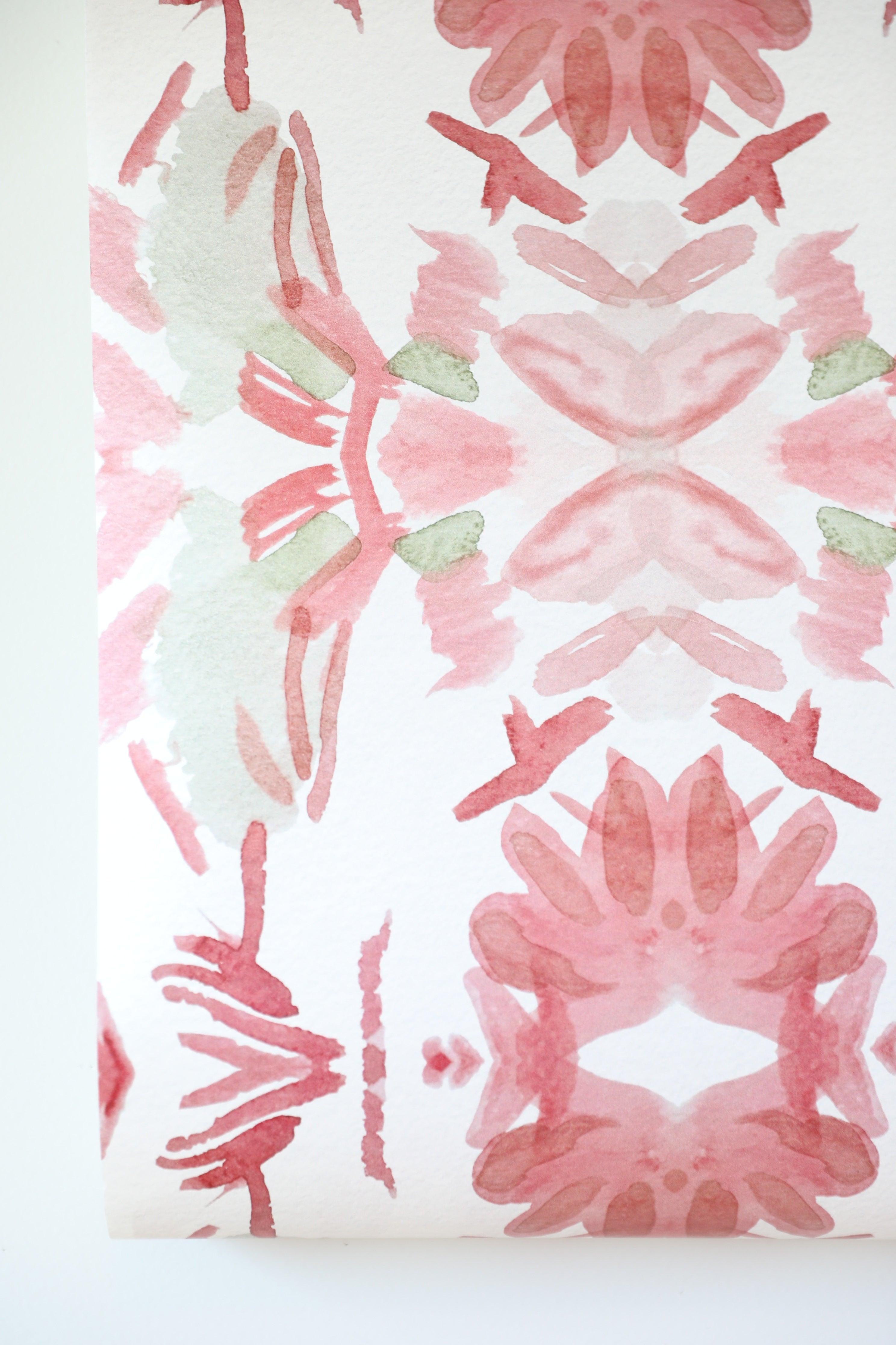 Luxury floral wallpaper featuring an artistic wildflower pattern in strawberry pink, blush, and soft green tones, designed for modern traditional interiors, bedrooms, powder rooms, and collected homes.