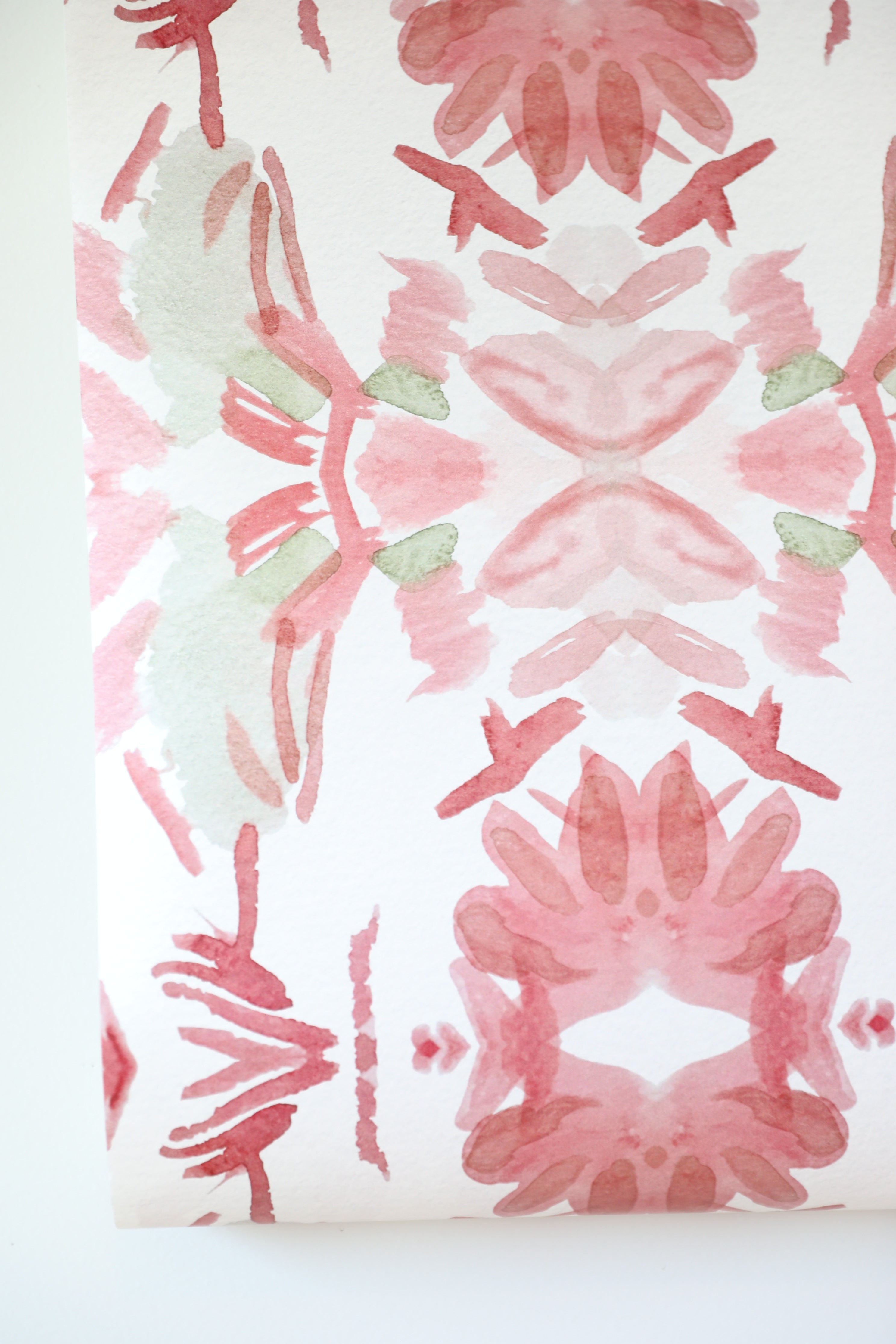 Luxury floral wallpaper featuring an artistic wildflower pattern in strawberry pink, blush, and soft green tones, designed for modern traditional interiors, bedrooms, powder rooms, and collected homes.