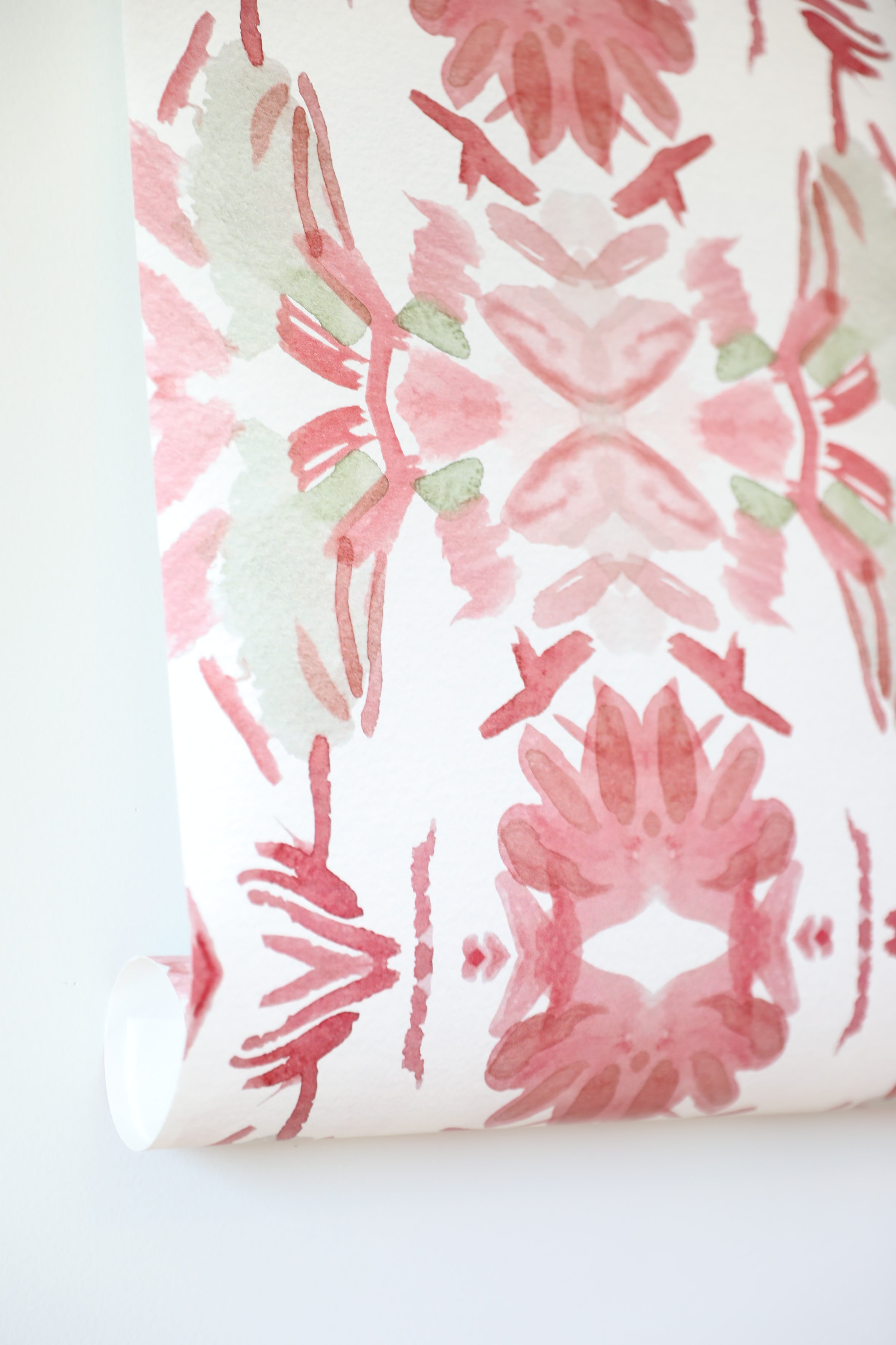 Luxury floral wallpaper featuring an artistic wildflower pattern in strawberry pink, blush, and soft green tones, designed for modern traditional interiors, bedrooms, powder rooms, and collected homes.