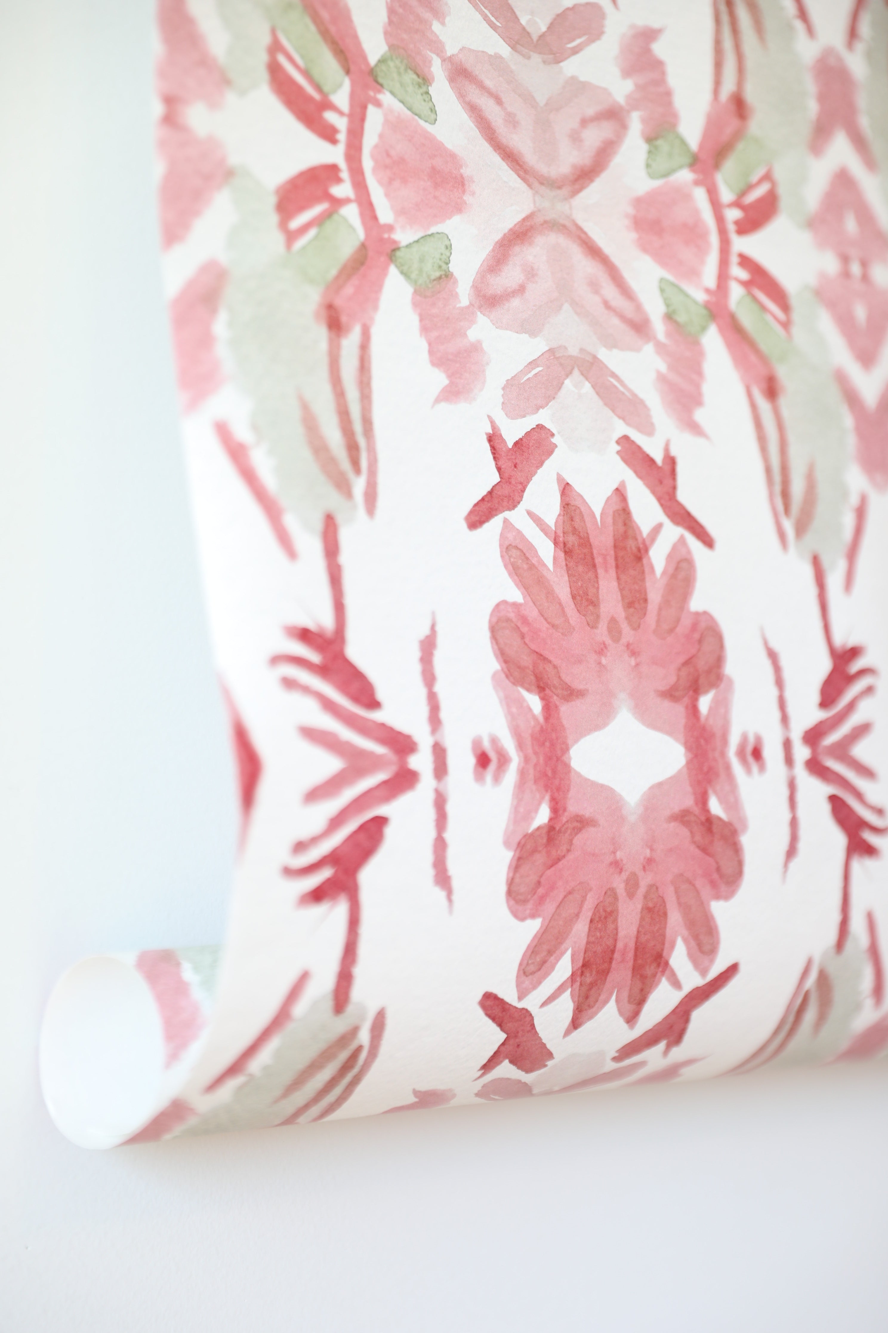 Luxury floral wallpaper featuring an artistic wildflower pattern in strawberry pink, blush, and soft green tones, designed for modern traditional interiors, bedrooms, powder rooms, and collected homes.