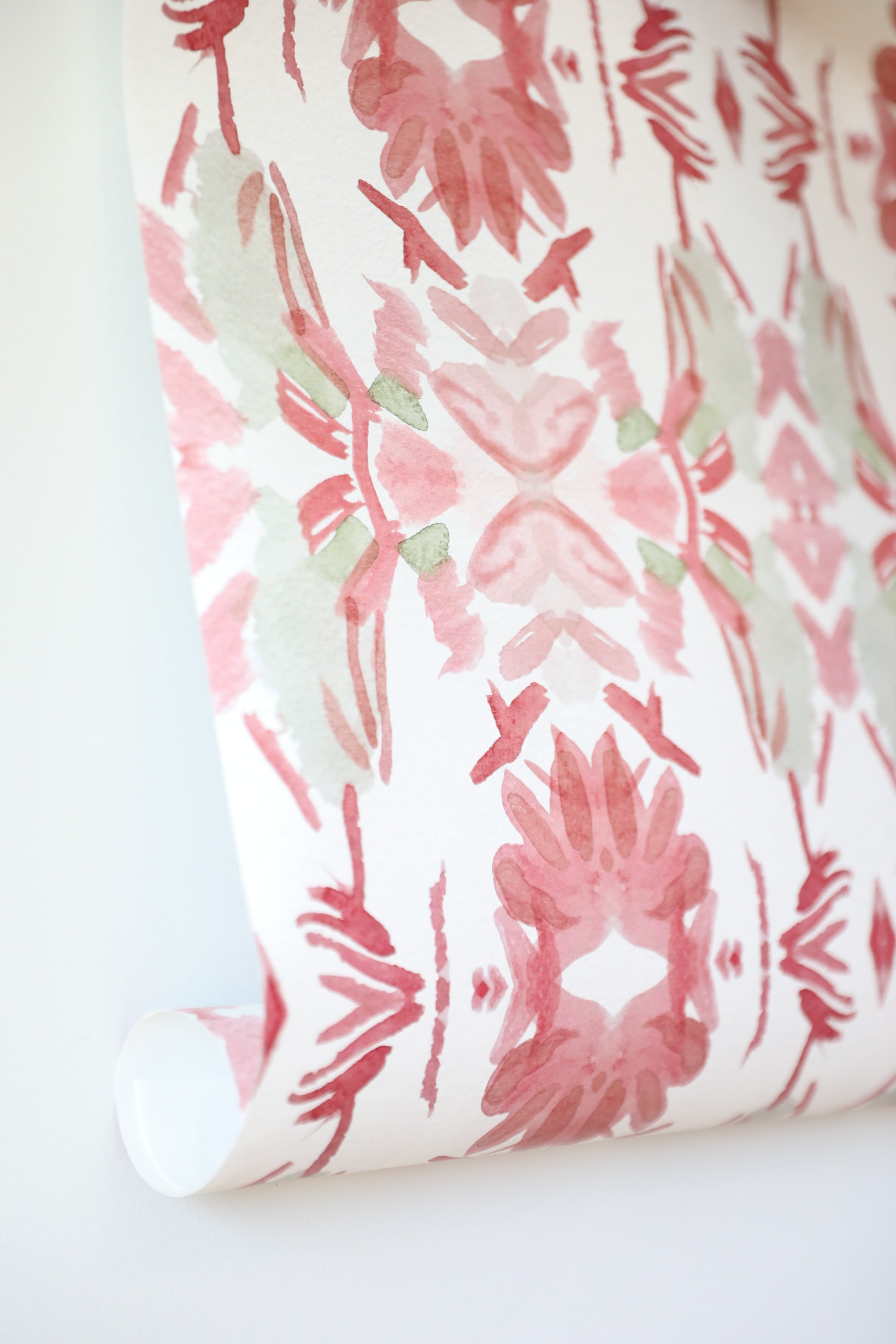 Luxury floral wallpaper featuring an artistic wildflower pattern in strawberry pink, blush, and soft green tones, designed for modern traditional interiors, bedrooms, powder rooms, and collected homes.