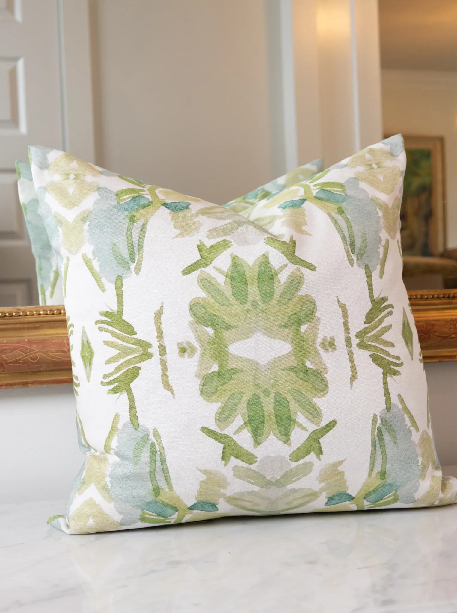 Luxury white and apple green botanical pillow with large-scale floral pattern inspired by Alaska wildflowers, handcrafted in England for contemporary and traditional interiors.