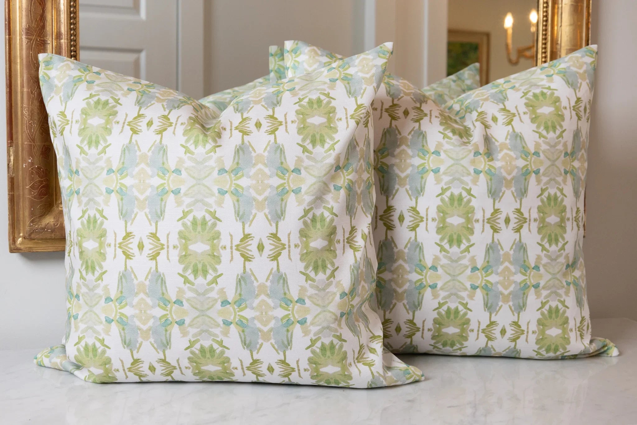Wildflowers I White & Apple Green luxury pillow featuring an artistic floral pattern on a soft white ground, handcrafted in England for traditional, modern traditional, and layered interior design projects.