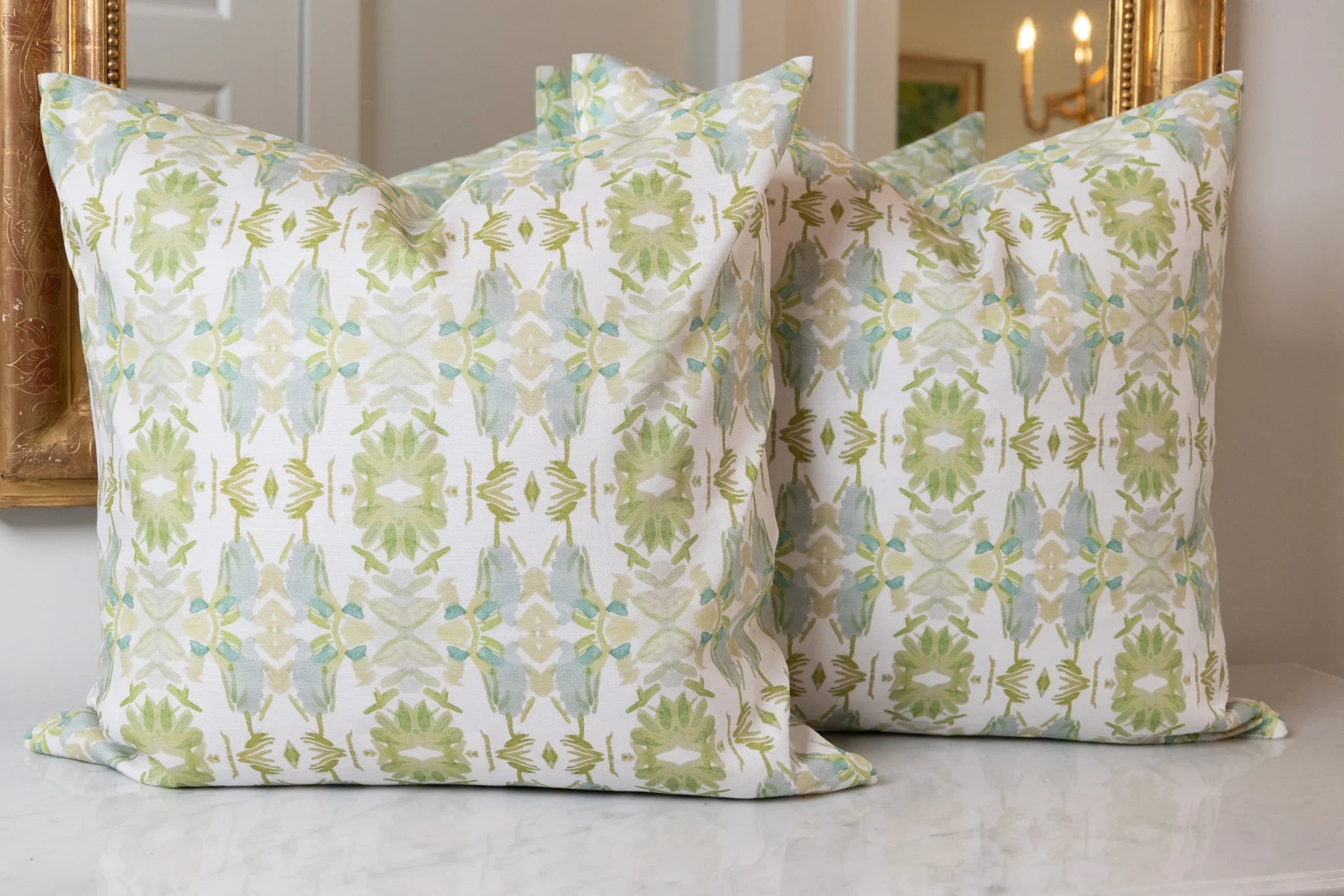 Wildflowers I White & Apple Green luxury pillow featuring an artistic floral pattern on a soft white ground, handcrafted in England for traditional, modern traditional, and layered interior design projects.