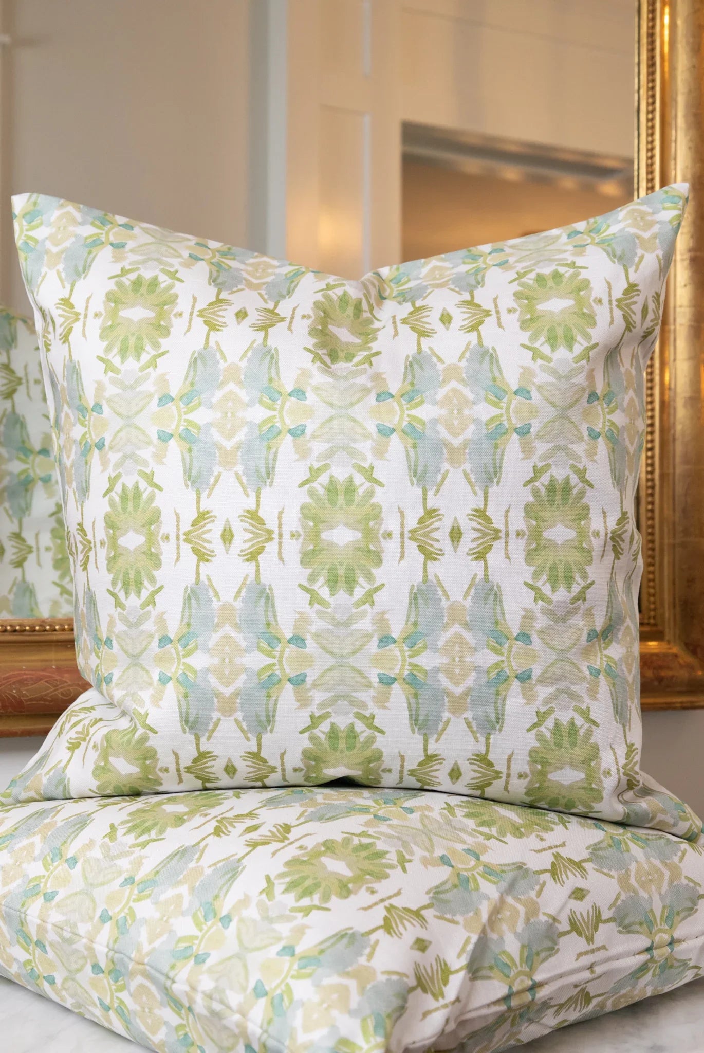 Wildflowers I White & Apple Green luxury pillow featuring an artistic floral pattern on a soft white ground, handcrafted in England for traditional, modern traditional, and layered interior design projects.